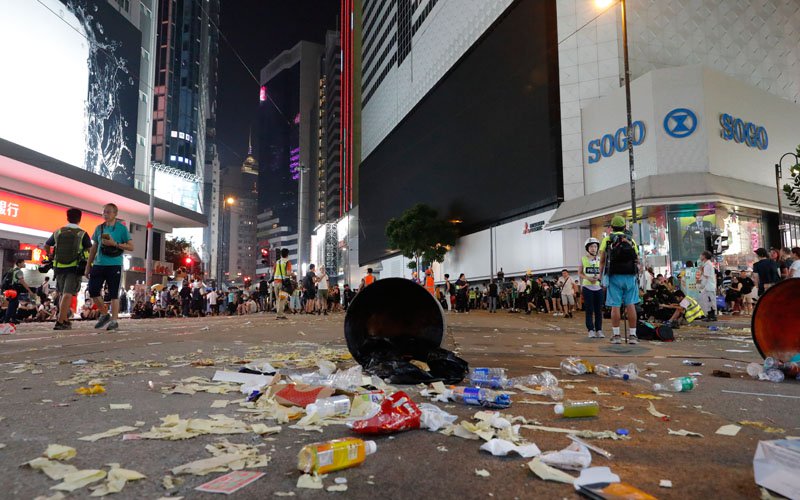 Hong Kong protesters defy mask ban as city grinds to halt