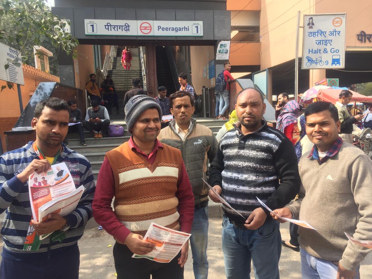 RSS BJP workers distributing pamphlets during Jan Sampark at Peeragarhi Metro Delhi election campaign