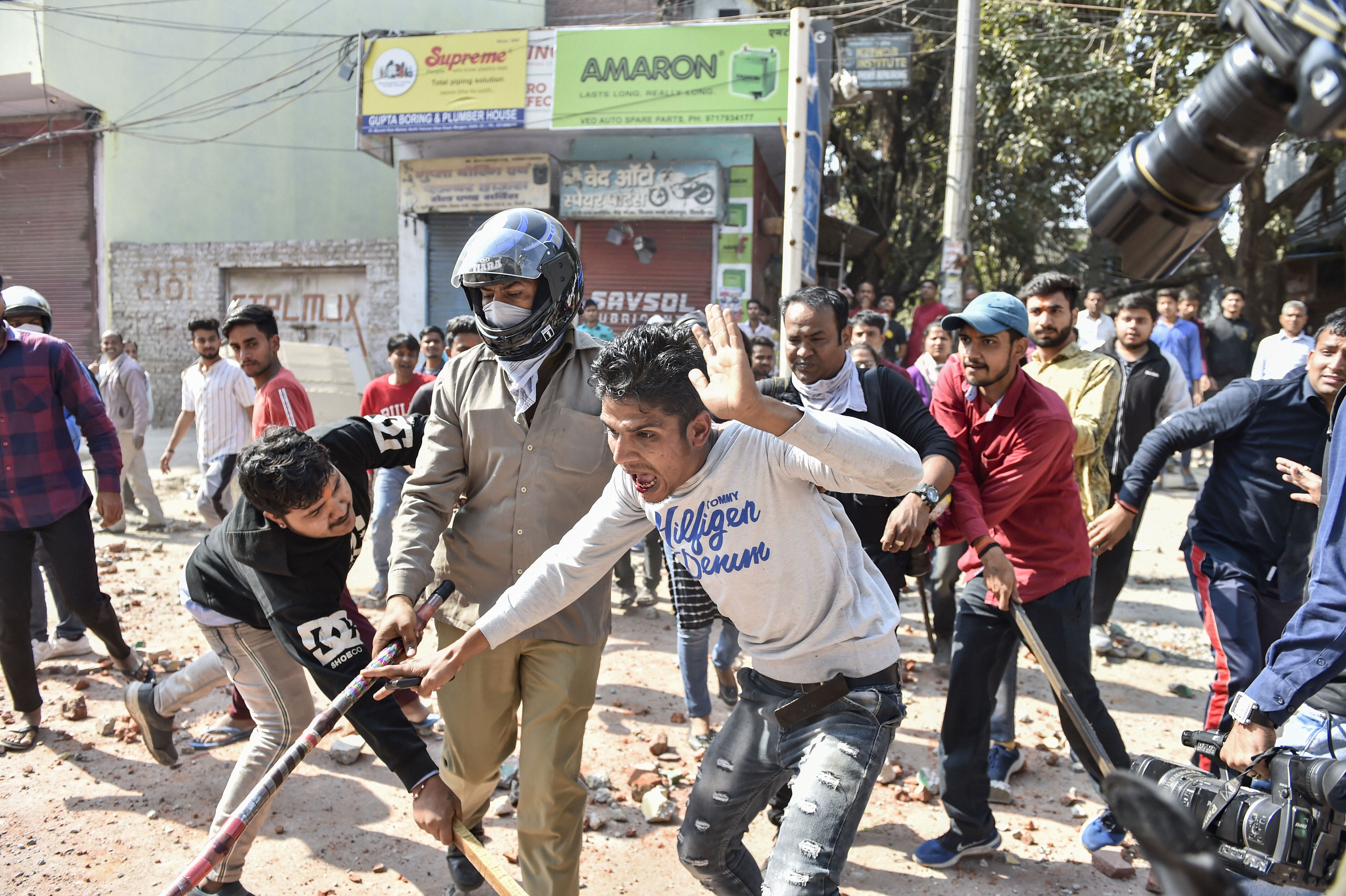 Riotous Delhi soaks in a dirty drain of communal divide