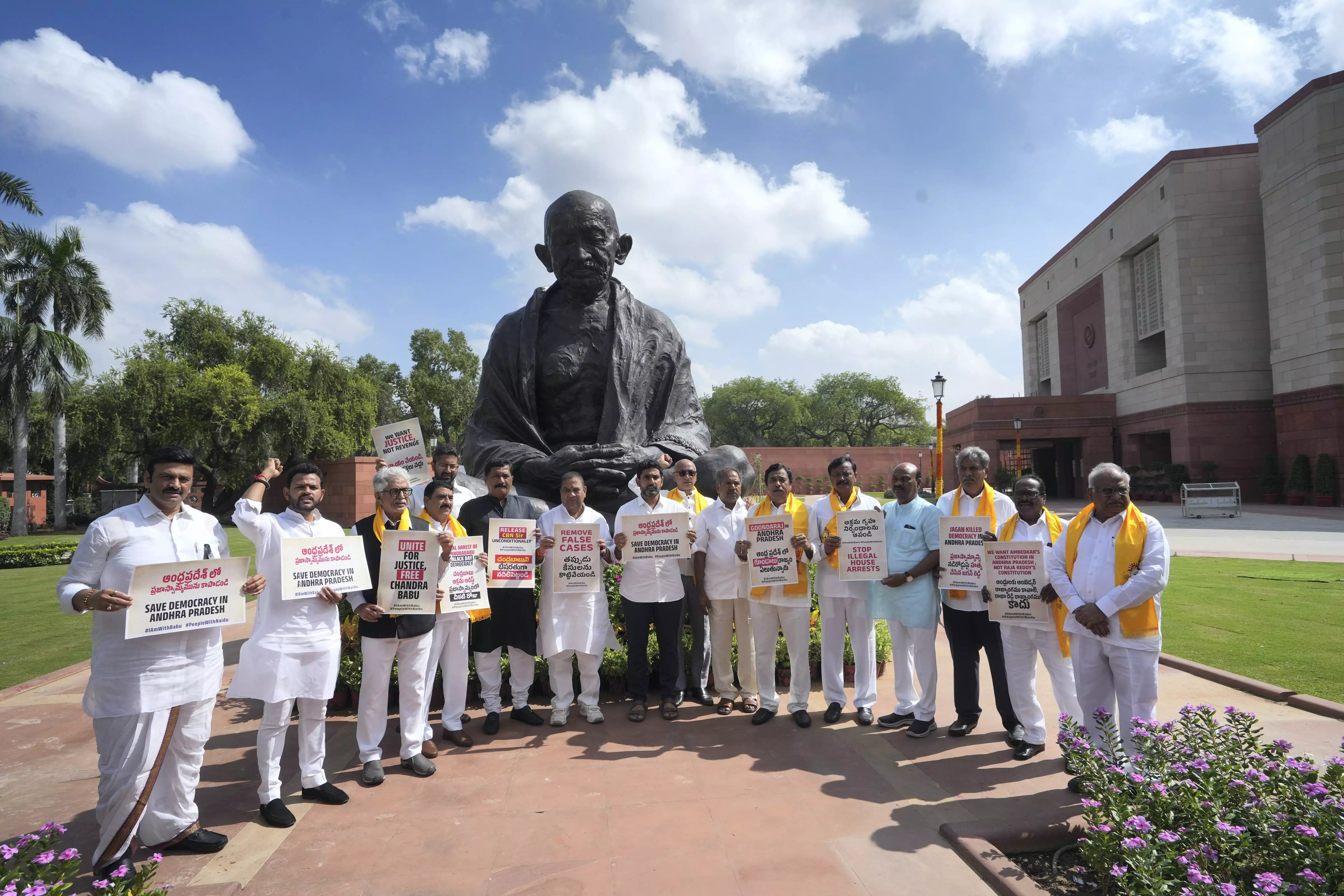 Telugu Desam Party (TDP) MPs with former Andhra Pradesh CM N Chandrababu Naidu’s son Nara Lokesh stage a protest at the Mahatma Gandhi statue over Naidus arrest on the first day of the Special session of Parliament, in New Delhi, Monday, September 18. Photo: PTI