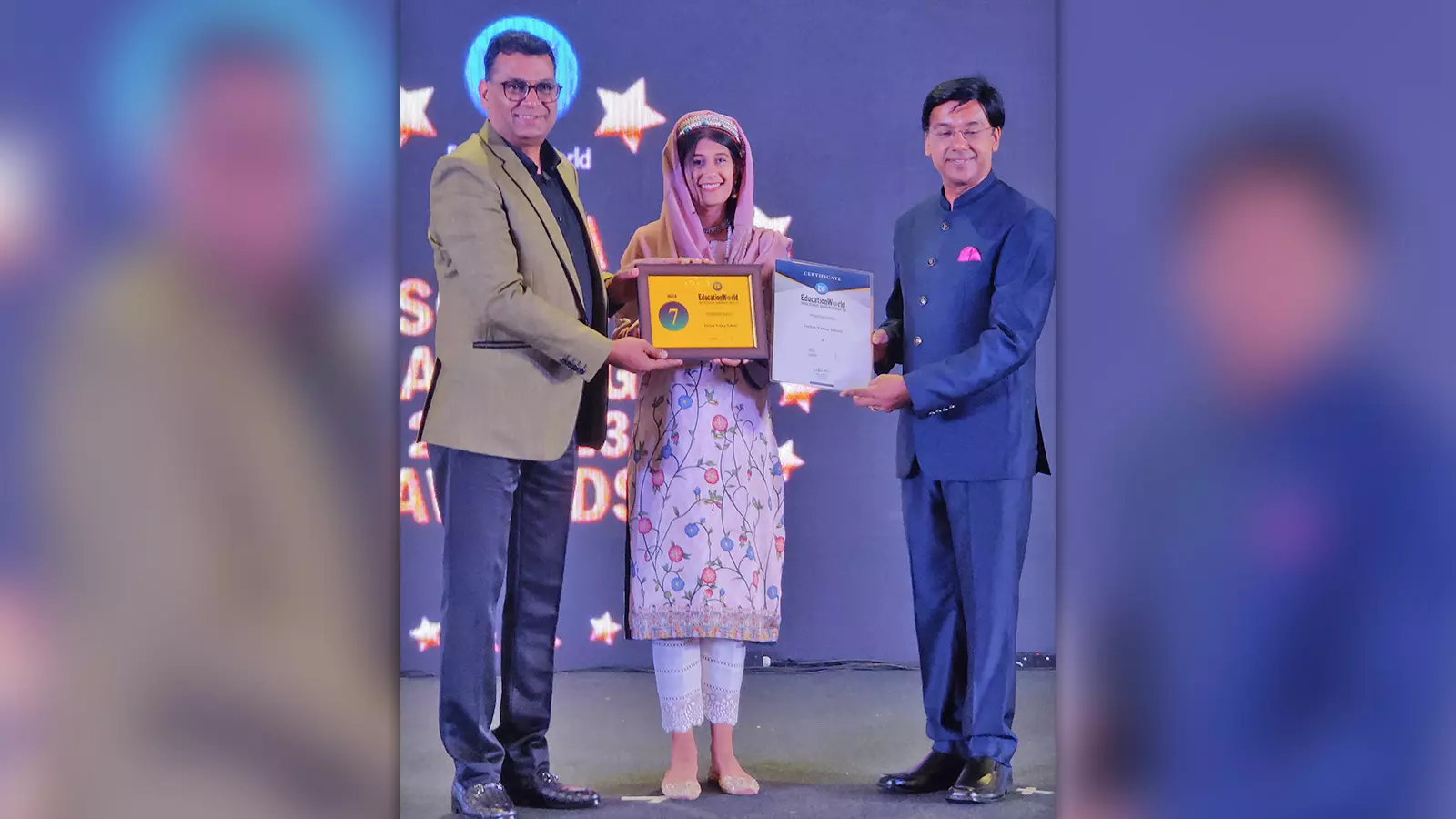 Sarah Shah accepting the award from Education World of India for Philanthropic Activities.