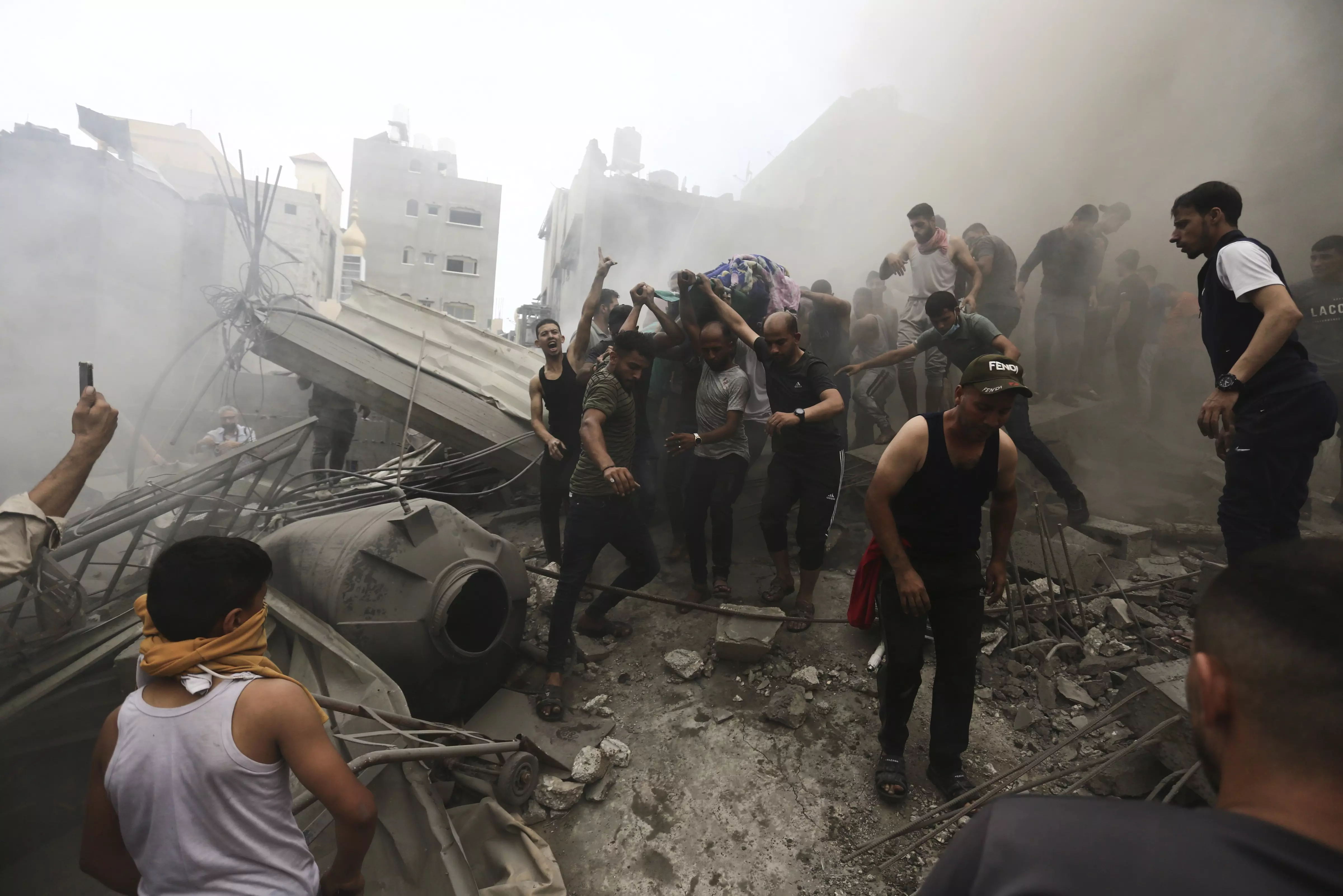 Palestinians remove a body from the rubble of a building after an Israeli airstrike in Jebaliya refugee camp, Gaza strip on Monday. Photo: PTI  