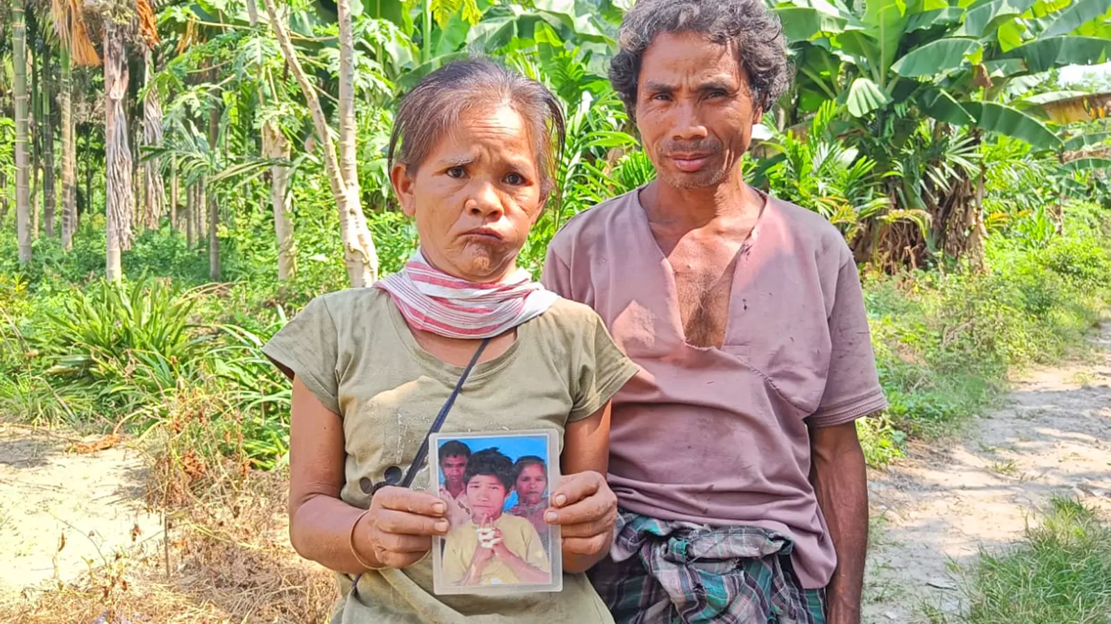 Purudhan Chakma (50) and his wife Liduvi Chakma (45) from Arunachal Pradeshs Changlang district hold the picture of their missing son.