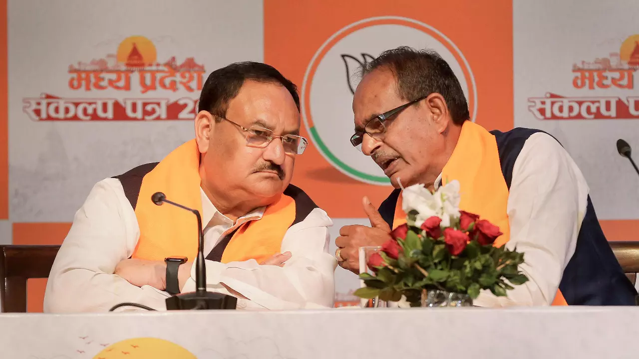 BJP National President JP Nadda with Madhya Pradesh Chief Minister Shivraj Singh Chouban during the release of the partys election manifesto for the state assembly elections, in Bhopal, on November 11 | PTI