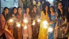 Young women burn sparkles to celebrate Diwali in Solapur, Maharashtra, on November 12 | PTI