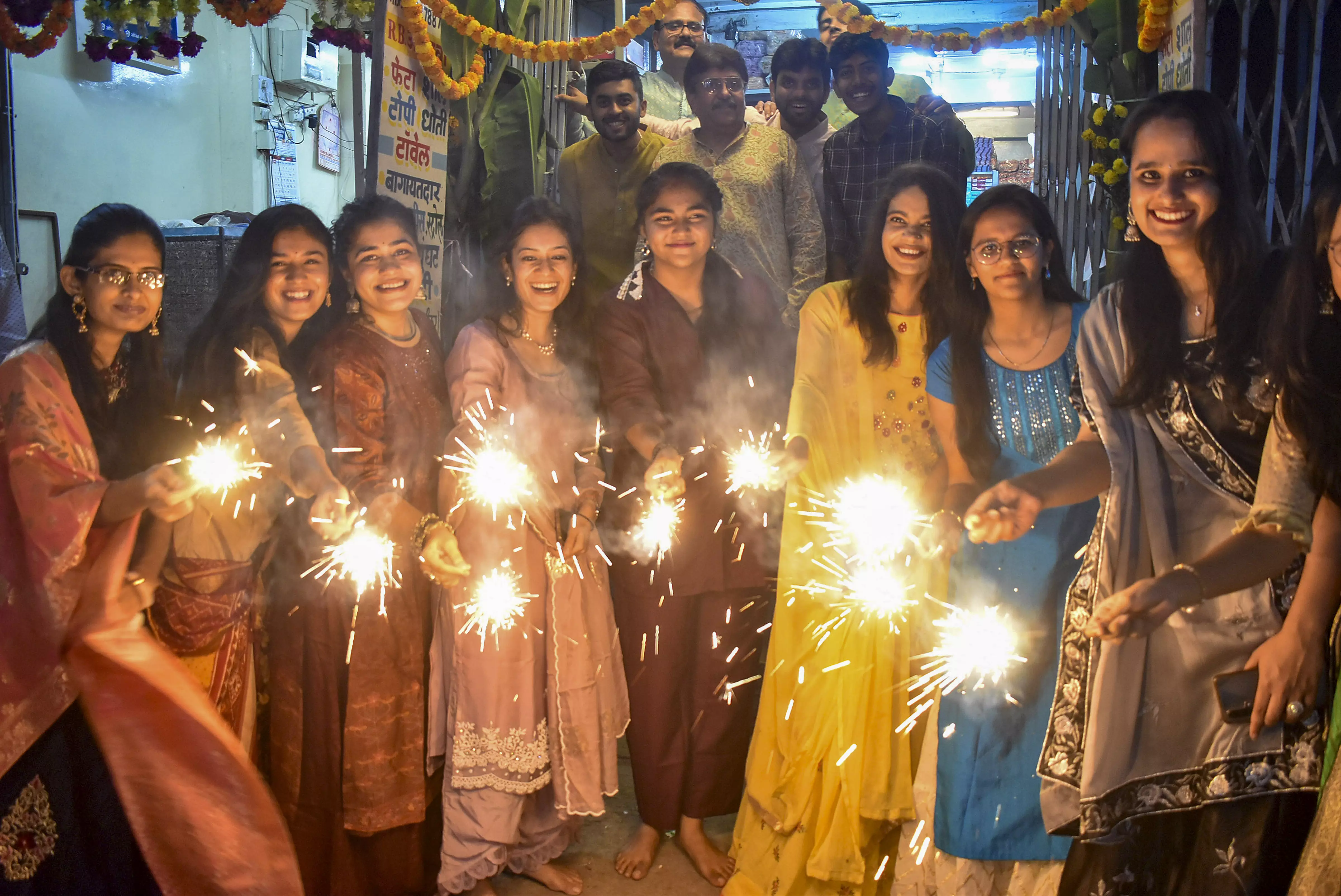 Young women burn sparkles to celebrate Diwali in Solapur, Maharashtra, on November 12 | PTI