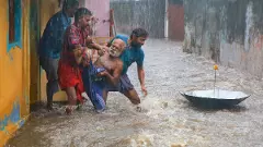 People rescue an elderly man from a flooded area during heavy rain in Kanyakumari district | PTI