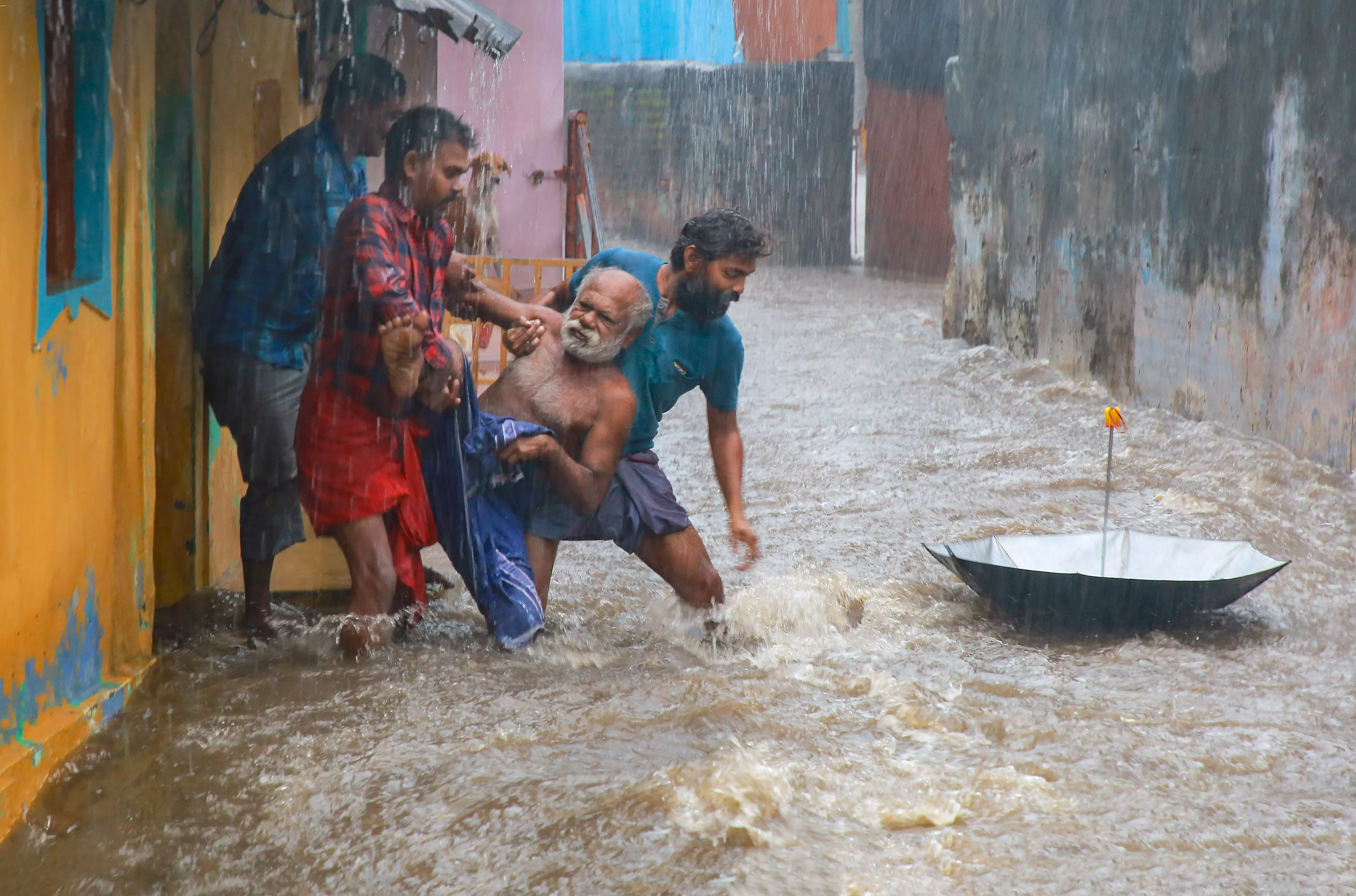 People rescue an elderly man from a flooded area during heavy rain in Kanyakumari district | PTI
