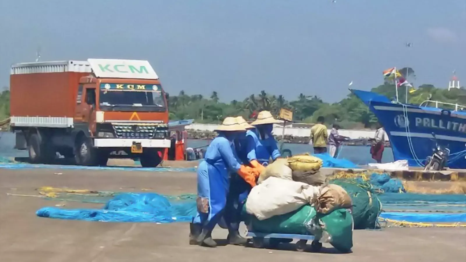 Suchitwa Keralam workers collecting plastic waste brought by fishermen from the seas at Neendakara Harbour.