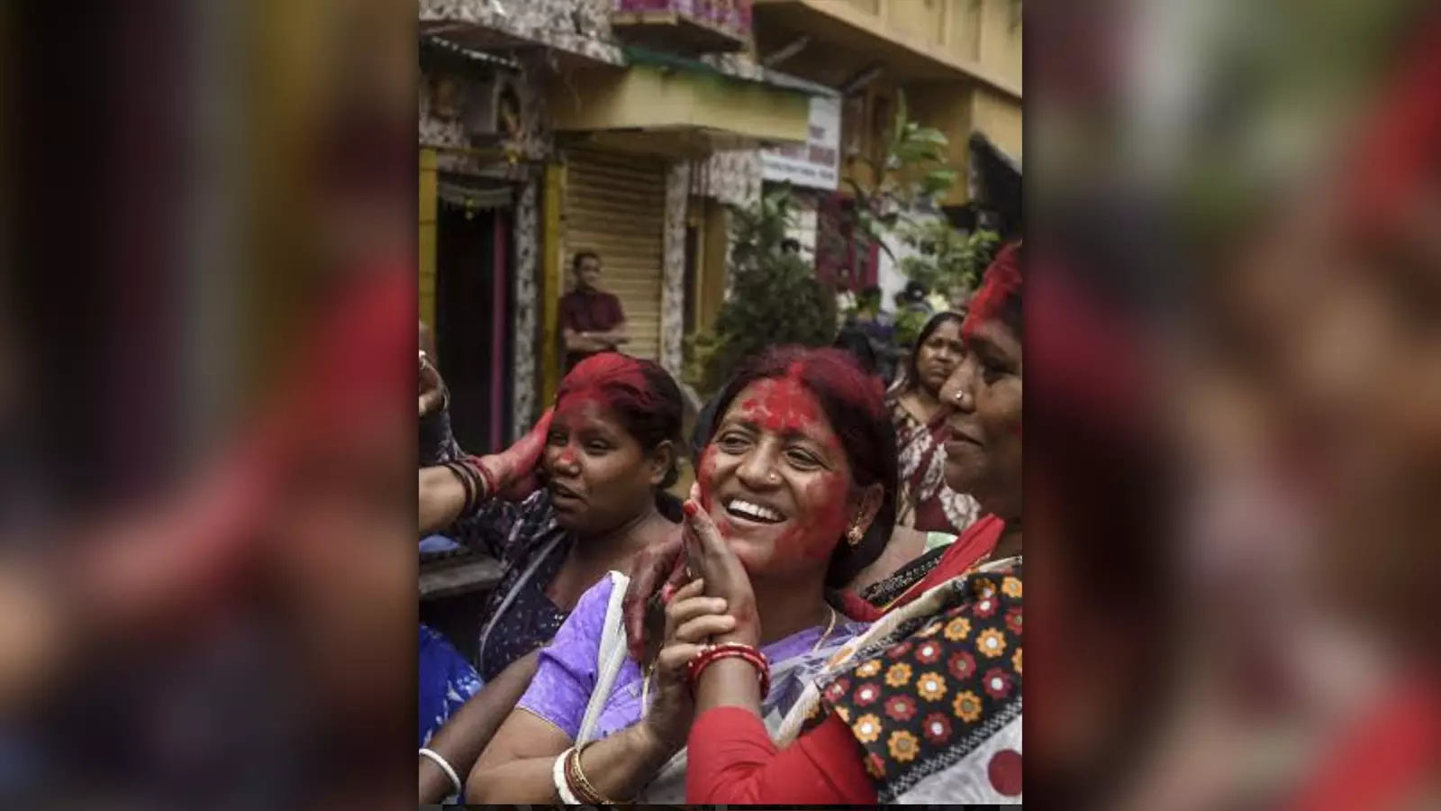 Women demanding an end to human trafficking and legalisation of sex trade play holi.