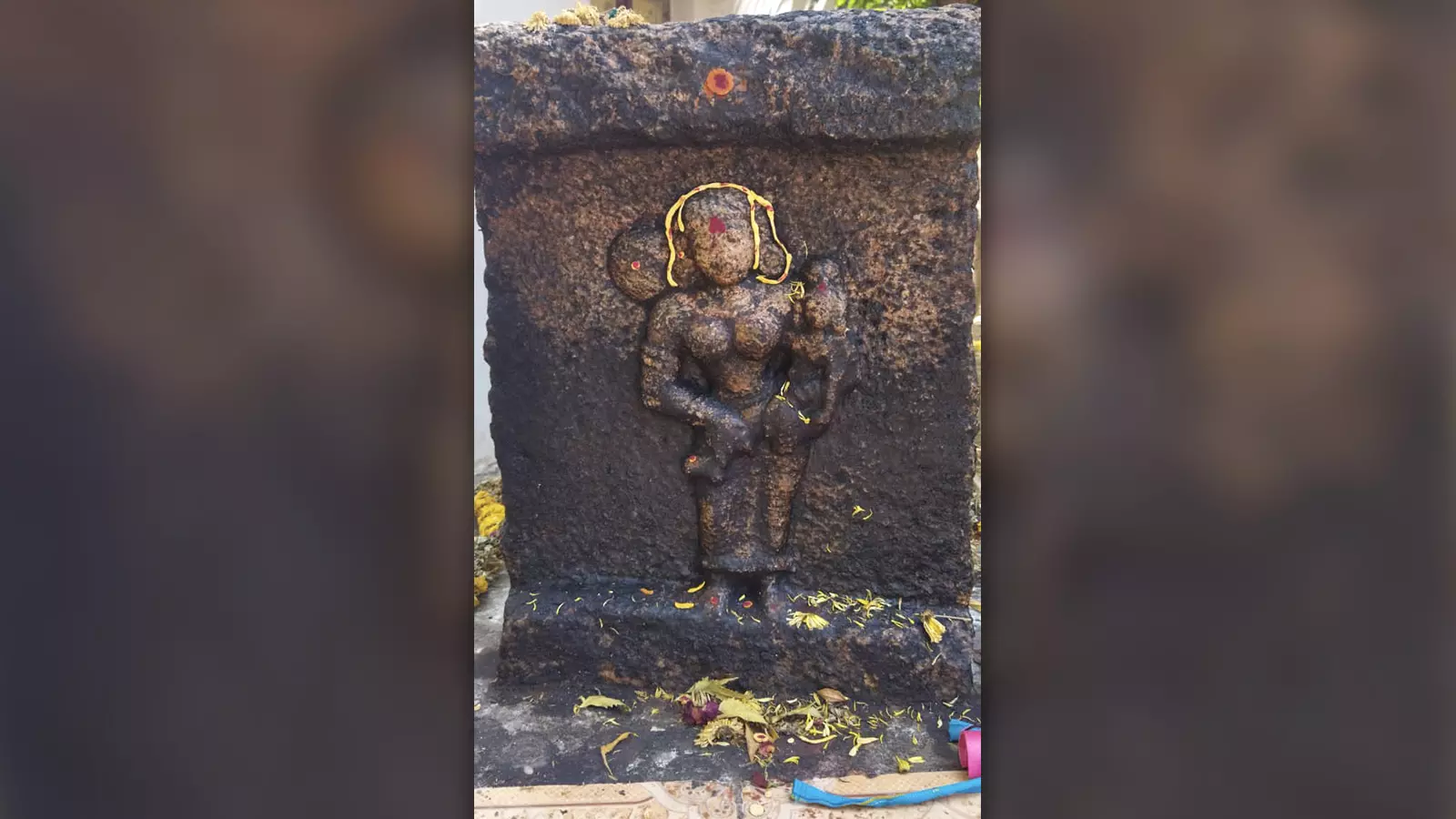 A heroine stone, showing a woman and child, which is worshipped. Villagers of Madurais Yanaimalai worship this structure as Andal. Experts, on the other hand, claim this structure was erected for a woman who died along with the child.
