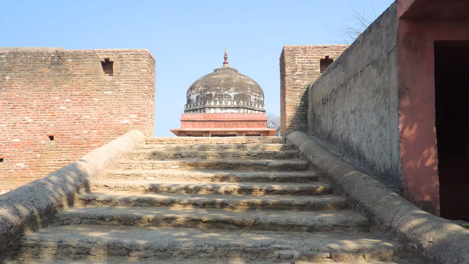 Lakshagraha is believed to be situated on top of a mound in the middle of fields at the confluence of the Hindon and Krishni rivers. 