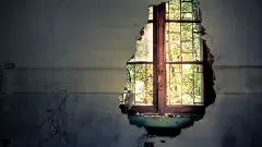 Destroyed wall with a closed window underneath.