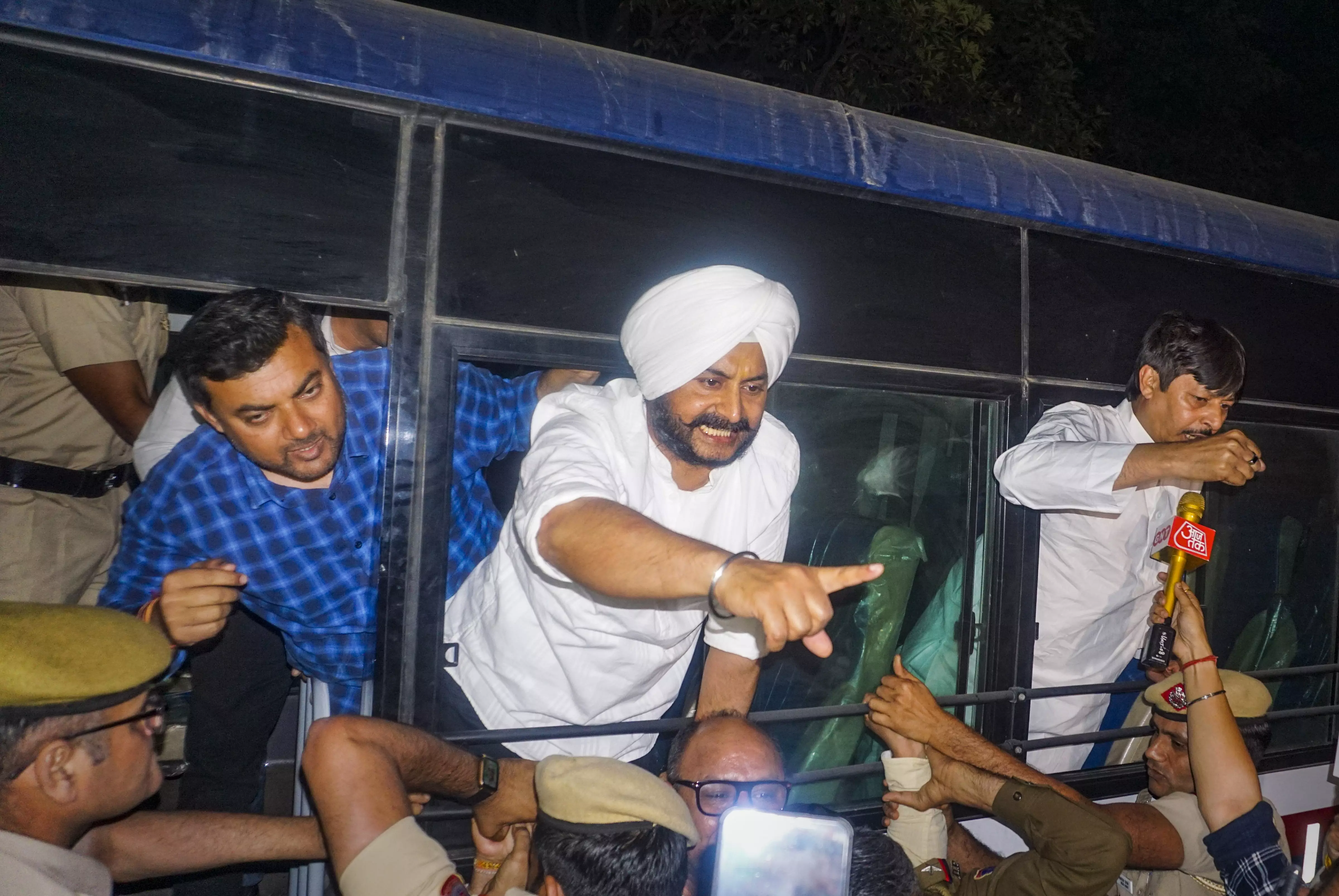 Police detain AAP MLAs Jarnail Singh, Rituraj and Reman who were protesting in support of Delhi Chief Minister Arvind Kejriwal outside his residence, in New Delhi, on Thursday, March 21. PTI