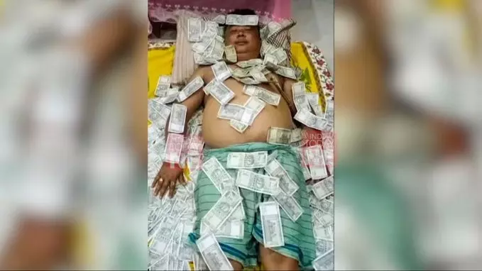 Assam: BJP ally UPPL member sleeps on Rs 500 notes; photo goes viral