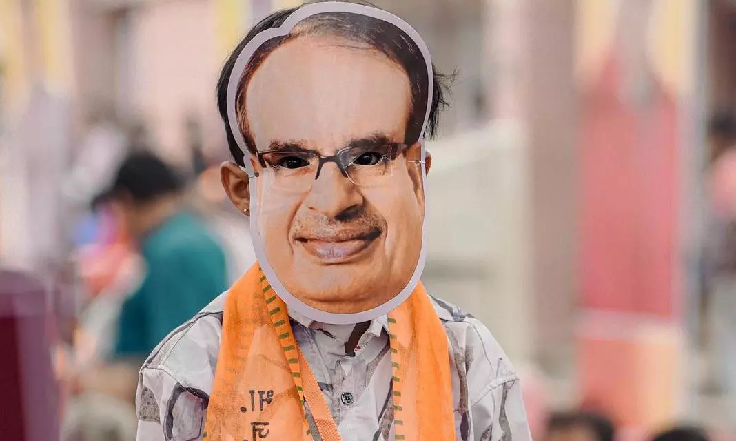 A follower of Chouhan wearing his mask