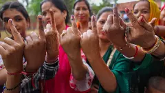 Women voters show their ink-marked fingers after casting votes at a polling station during the first phase of Lok Sabha polls in Kathua district (Jammu) on Friday. Photo: PTI