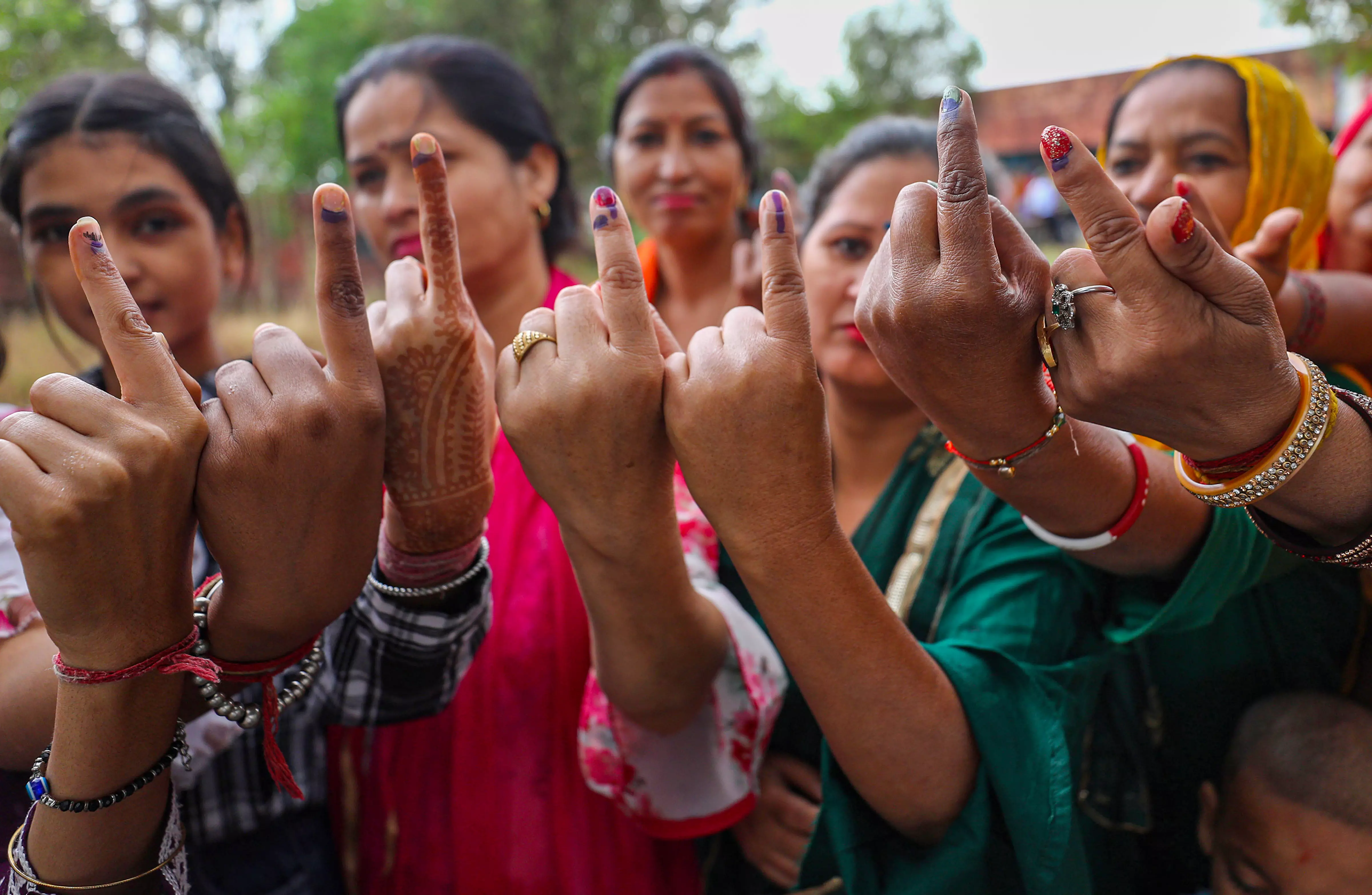Women voters show their ink-marked fingers after casting votes at a polling station during the first phase of Lok Sabha polls in Kathua district (Jammu) on Friday. Photo: PTI