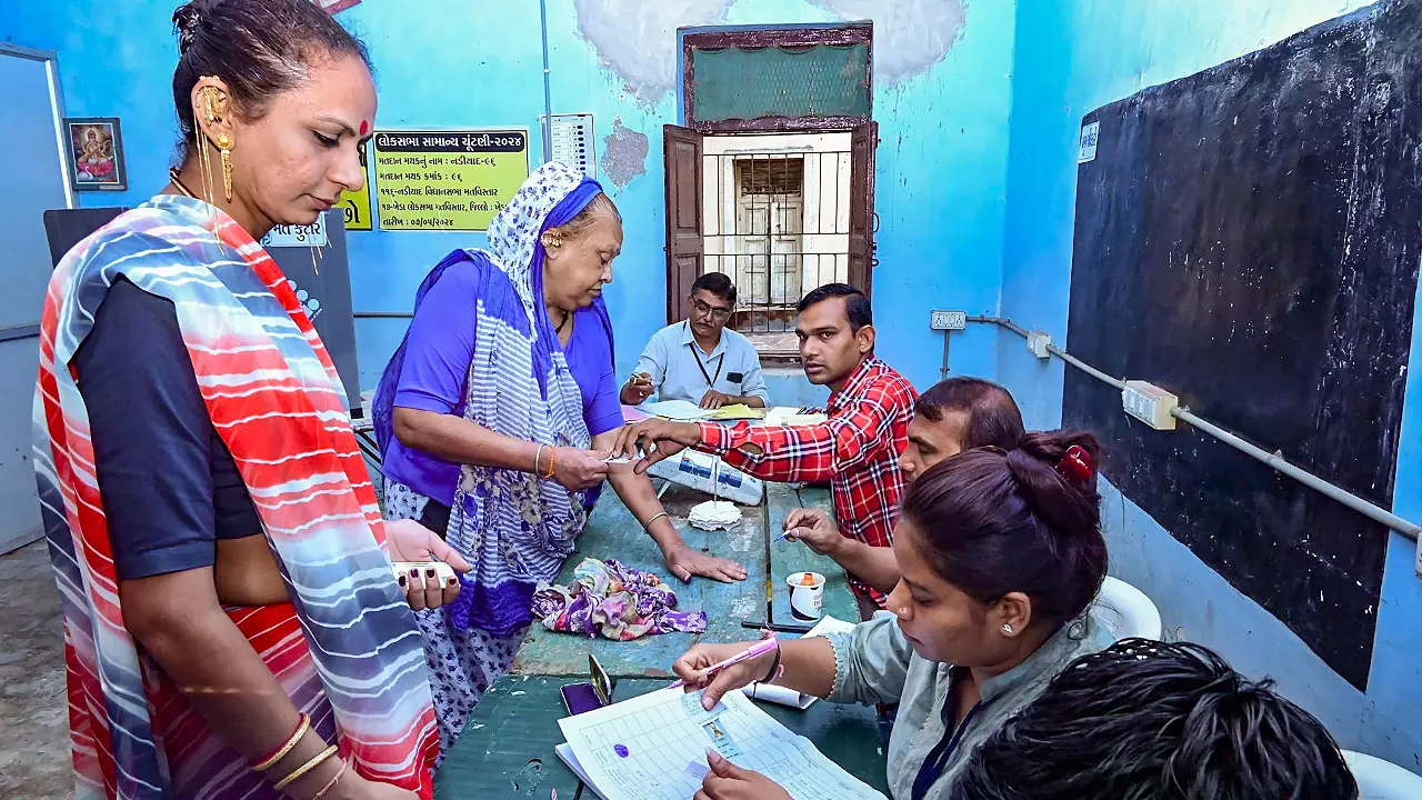Voting process on at a polling station in Kheda, Gujarat,