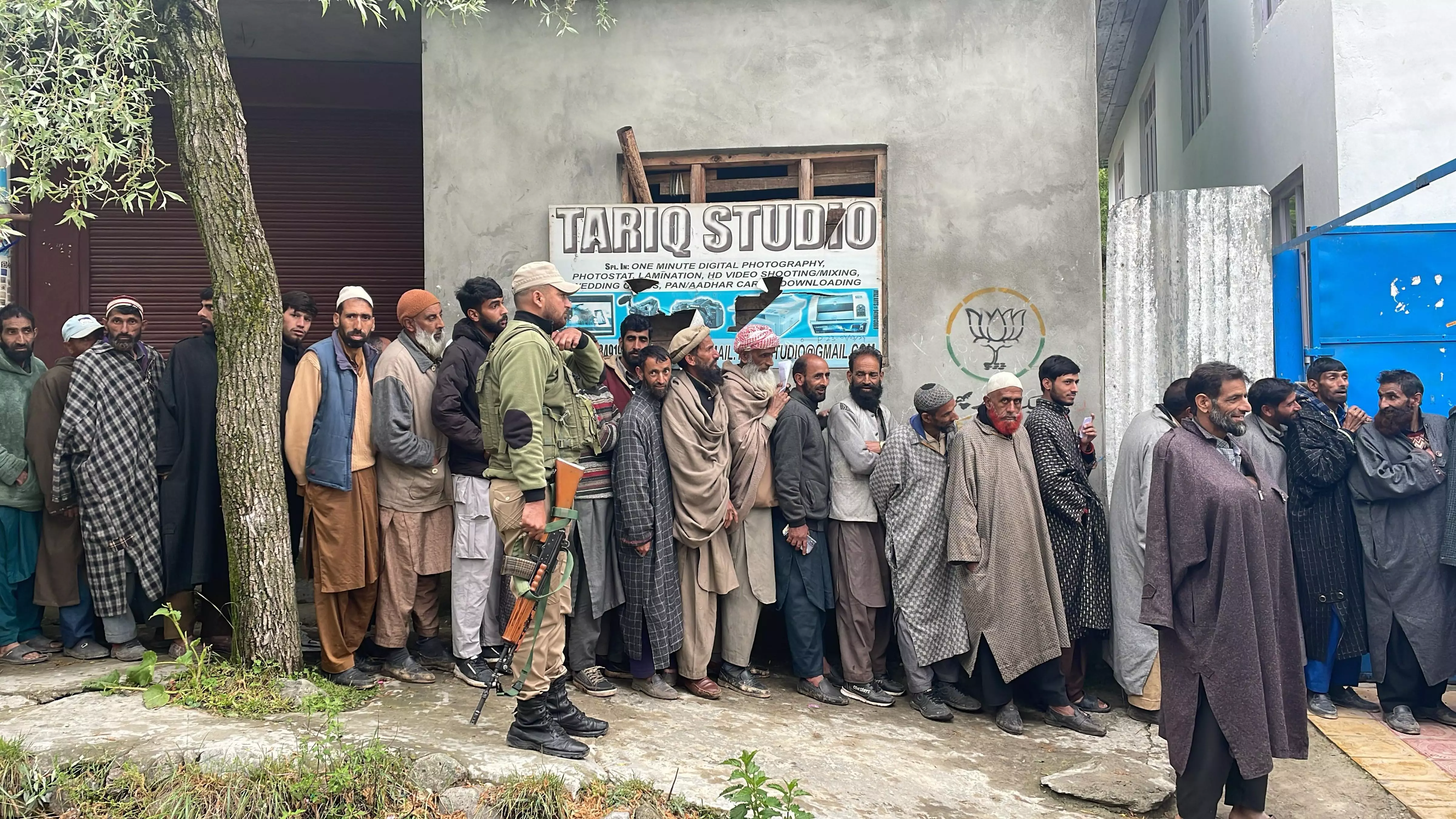 People stand in a queue to cast their votes at a polling station during the fourth phase of Lok Sabha elections at Fakeer Gujri on the outskirts of Srinagar. PTI