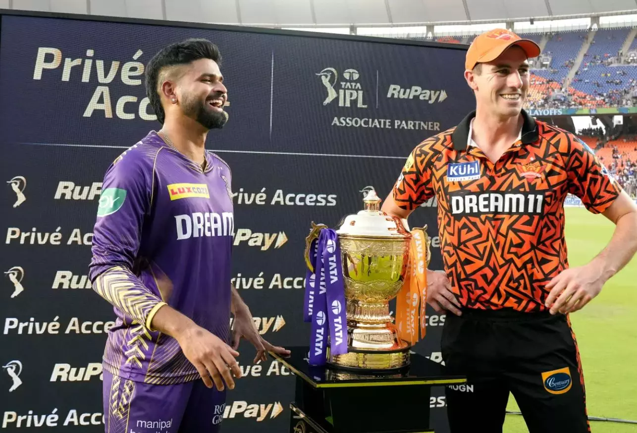 Captains Shreyas Iyer (KKR) and Pat Cummins (SRH) pose with the IPL 2024 trophy