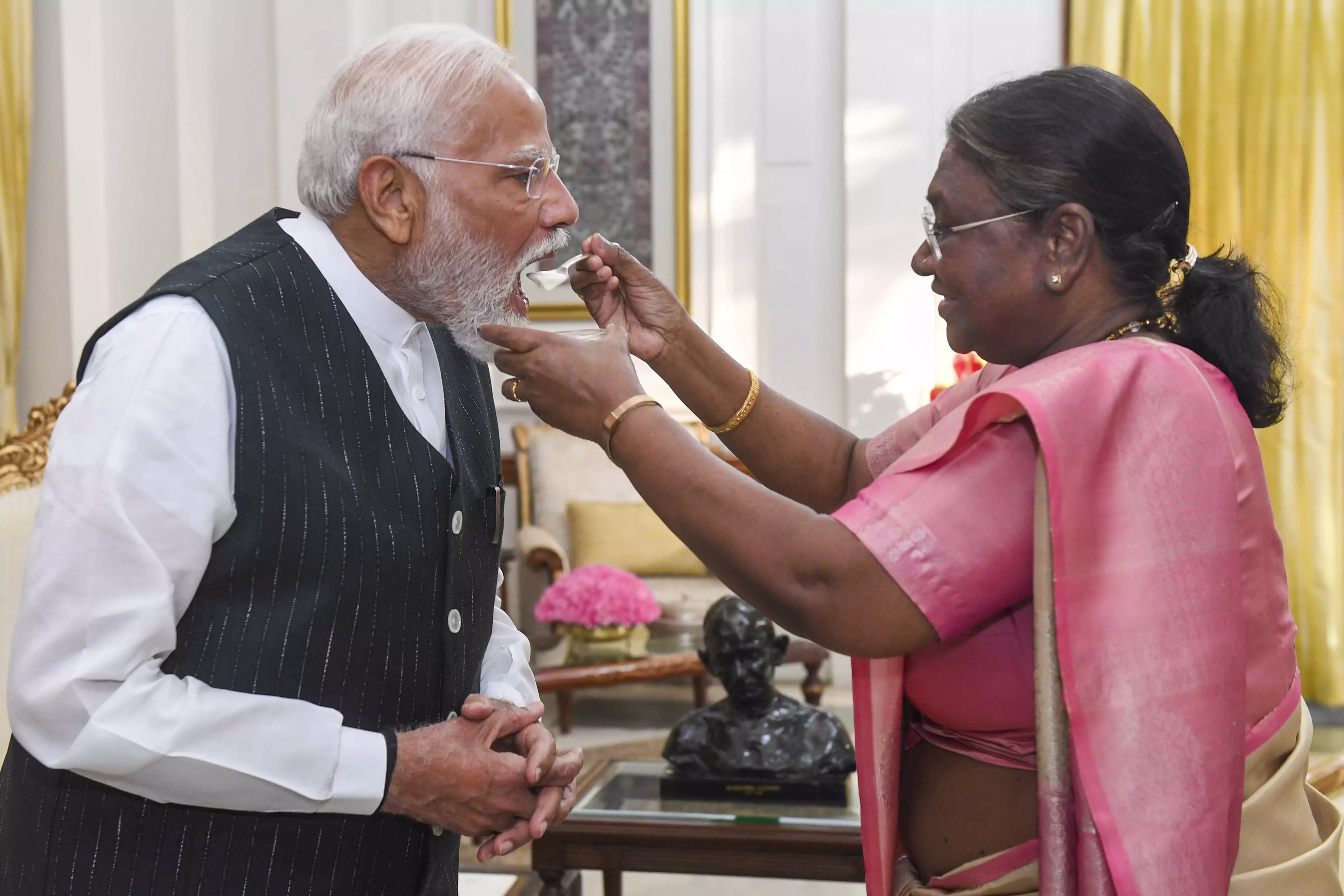 President Droupadi Murmu offers curd to NDA Parliamentary Party leader Narendra Modi after appointing the latter as Prime Minister-designate during a meeting at the Rashtrapati Bhavan ahead of government formation, in New Delhi, on Friday, June 7, 2024. PTI (Via Rashtrapati Bhavan)