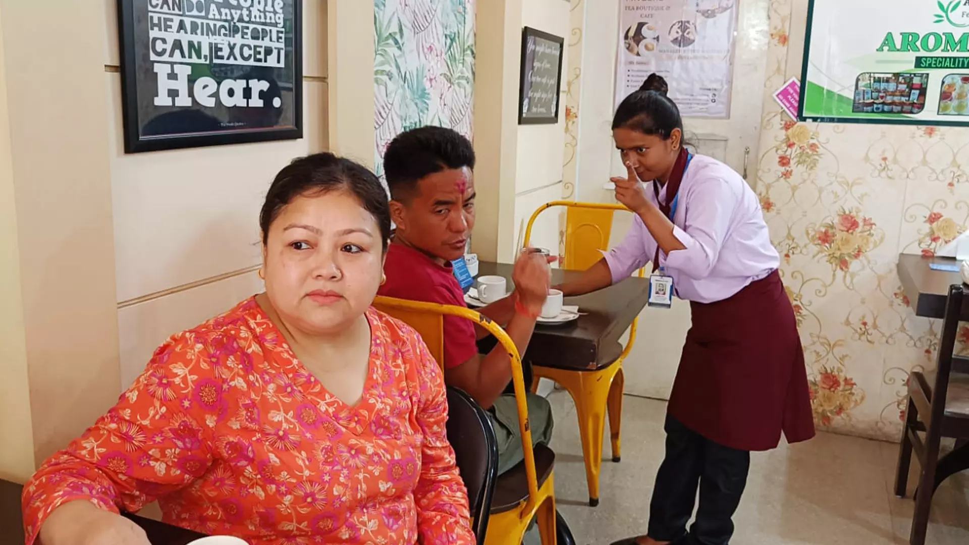 Labhita Nath interacts with customers at the cafe in sign language.