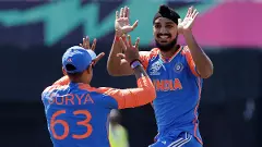 Indias Arshdeep Singh, right, celebrates with teammate Suryakumar Yadav
