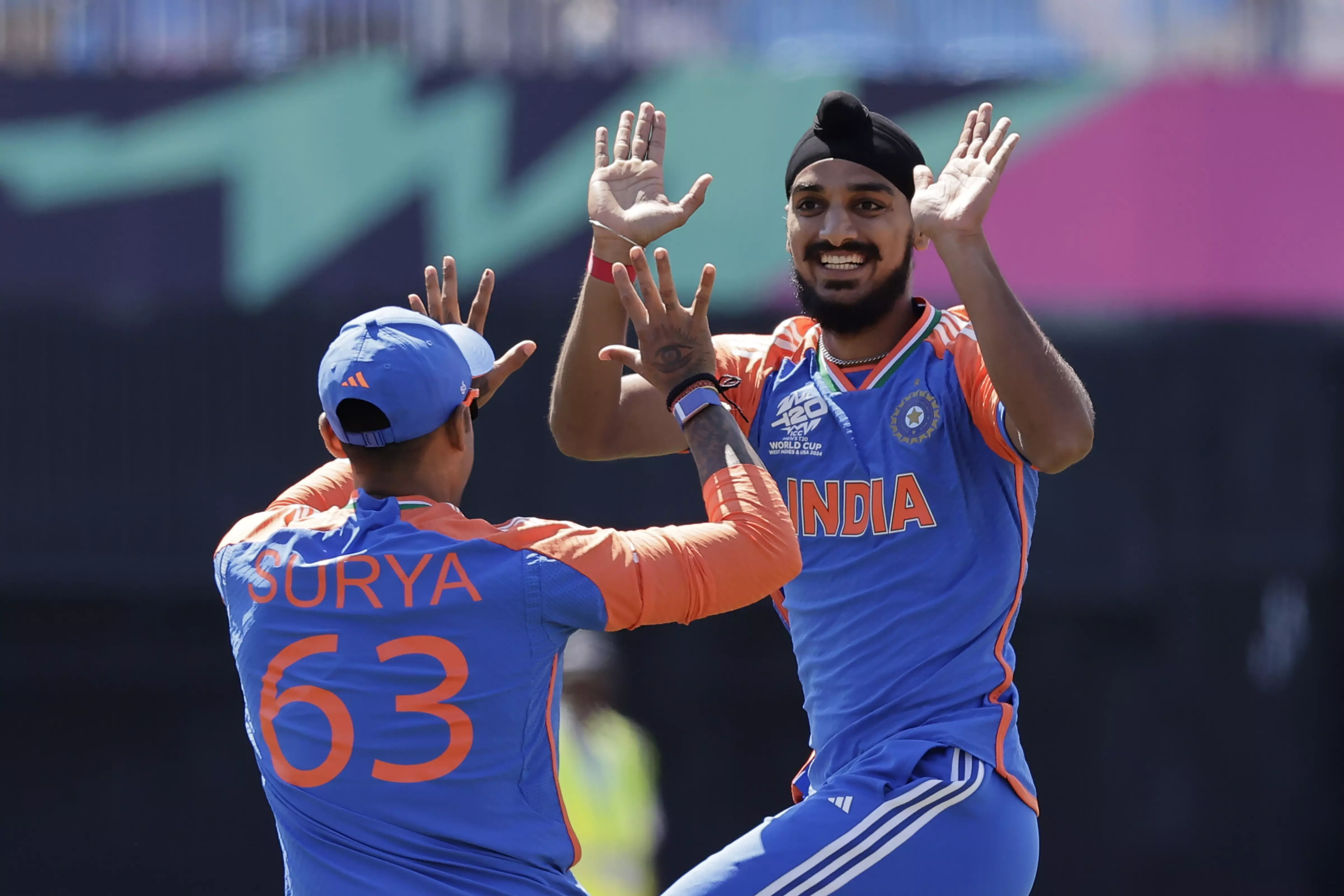 Indias Arshdeep Singh, right, celebrates with teammate Suryakumar Yadav