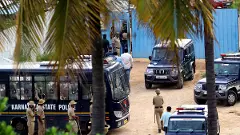 Police vehicles parked near the crime scene of the Renukaswamy murder case