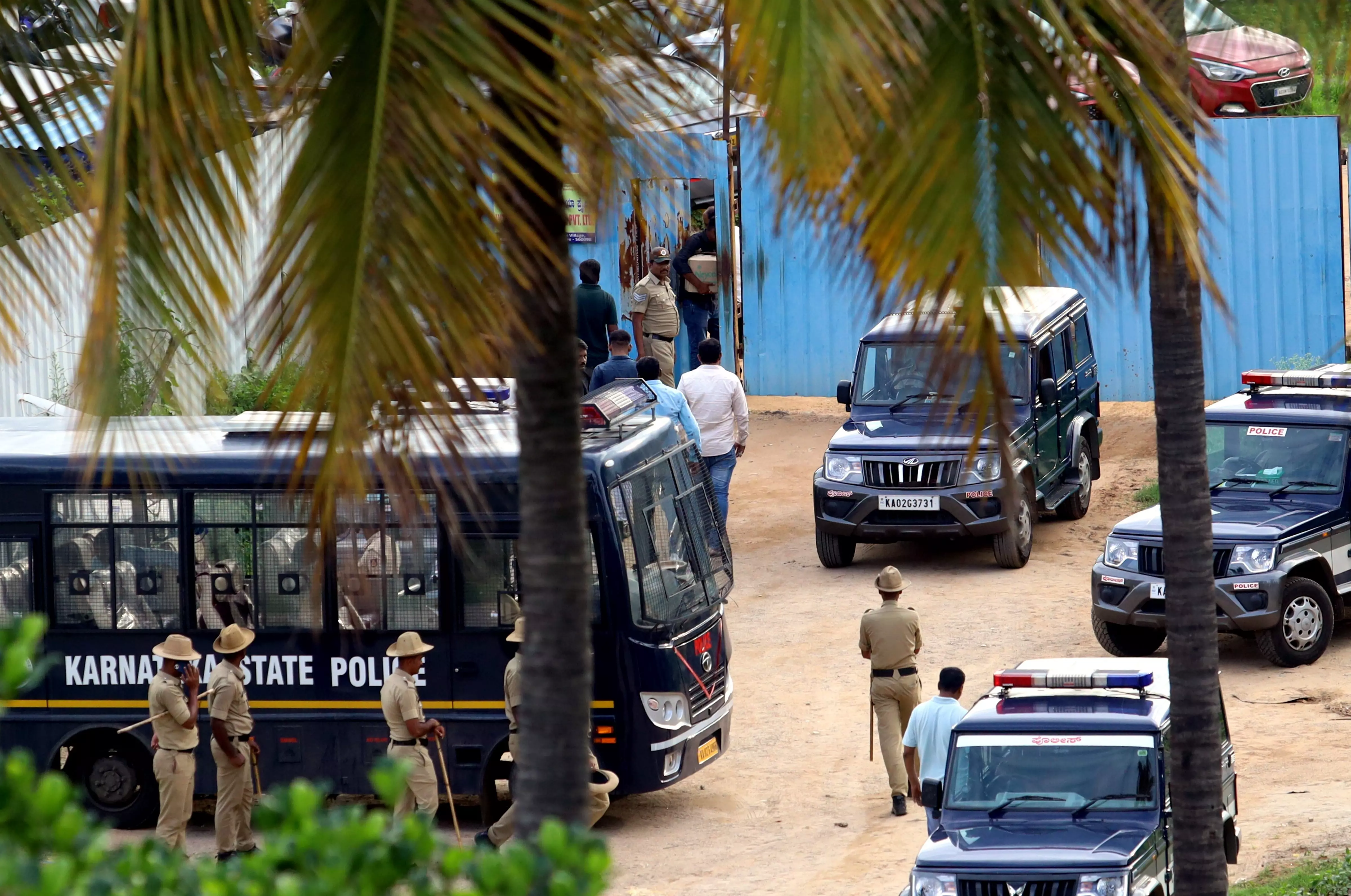 Police vehicles parked near the crime scene of the Renukaswamy murder case