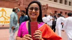 TMC MP Mahua Moitra holds a copy of the Constitution of India