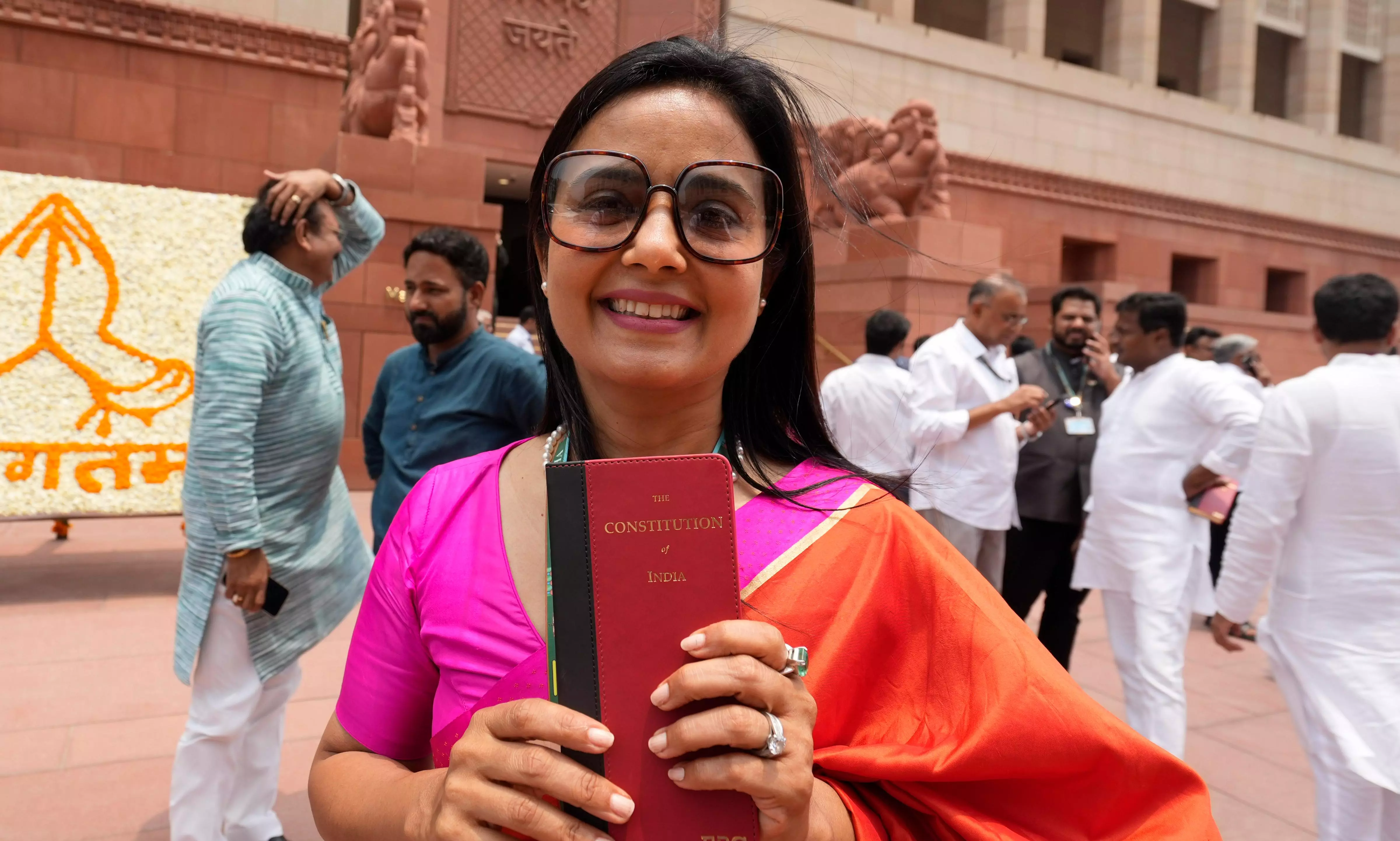 TMC MP Mahua Moitra holds a copy of the Constitution of India