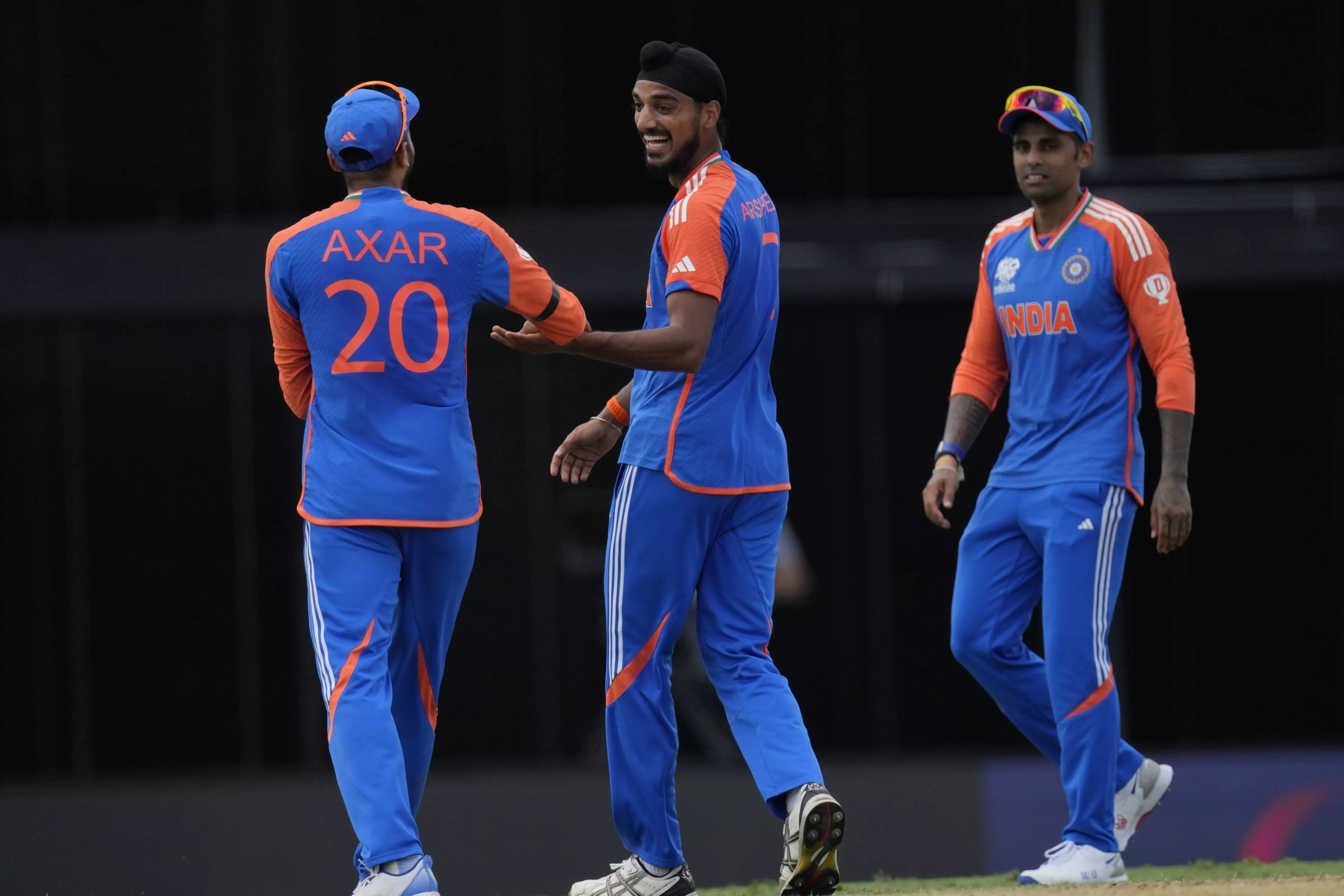 Indias Arshdeep Singh (centre) celebrates a wicket with Axar Patel (left) and Suryakumar Yadav