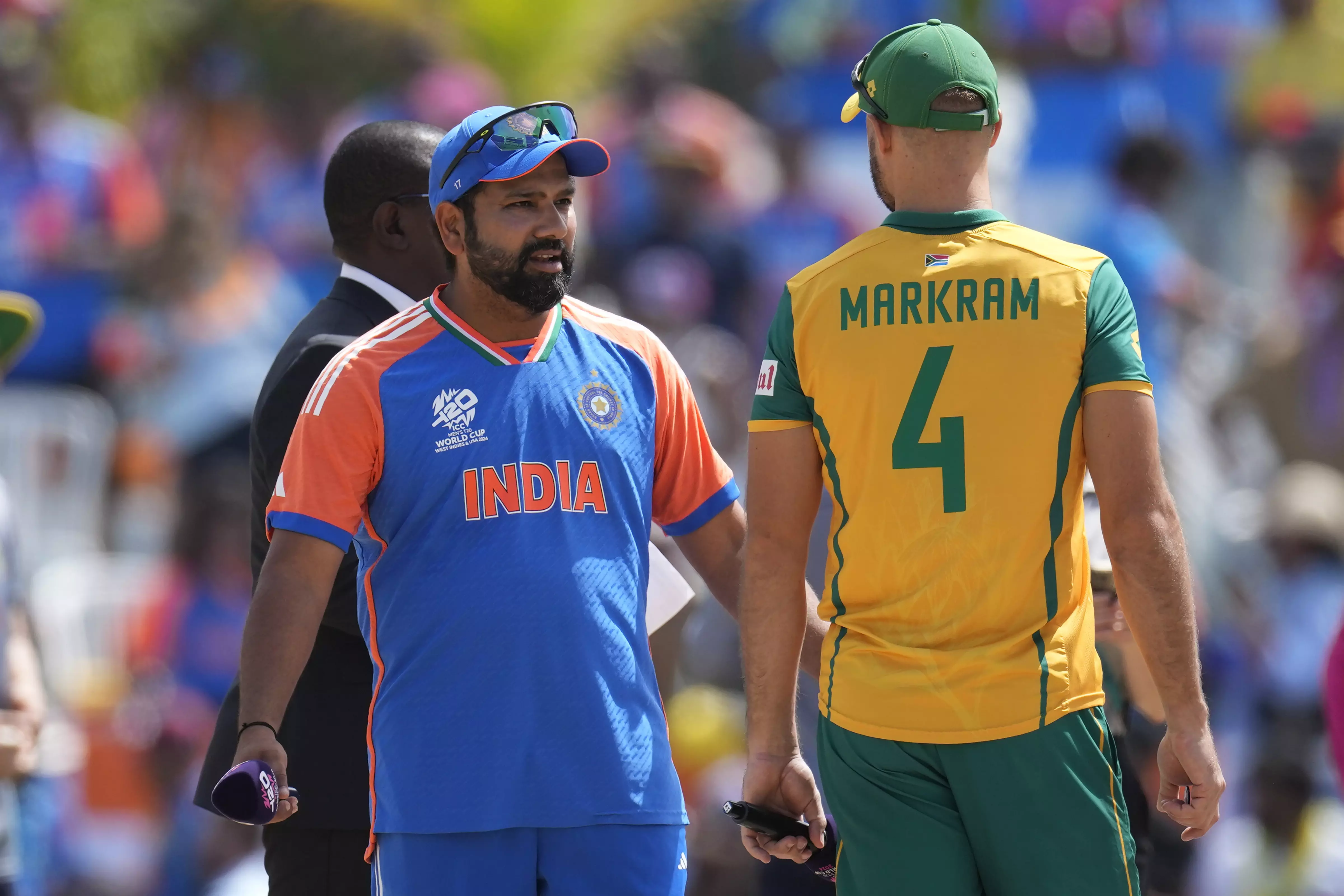 Indias captain Rohit Sharma, left, speaks to South Africas captain Aiden Markram