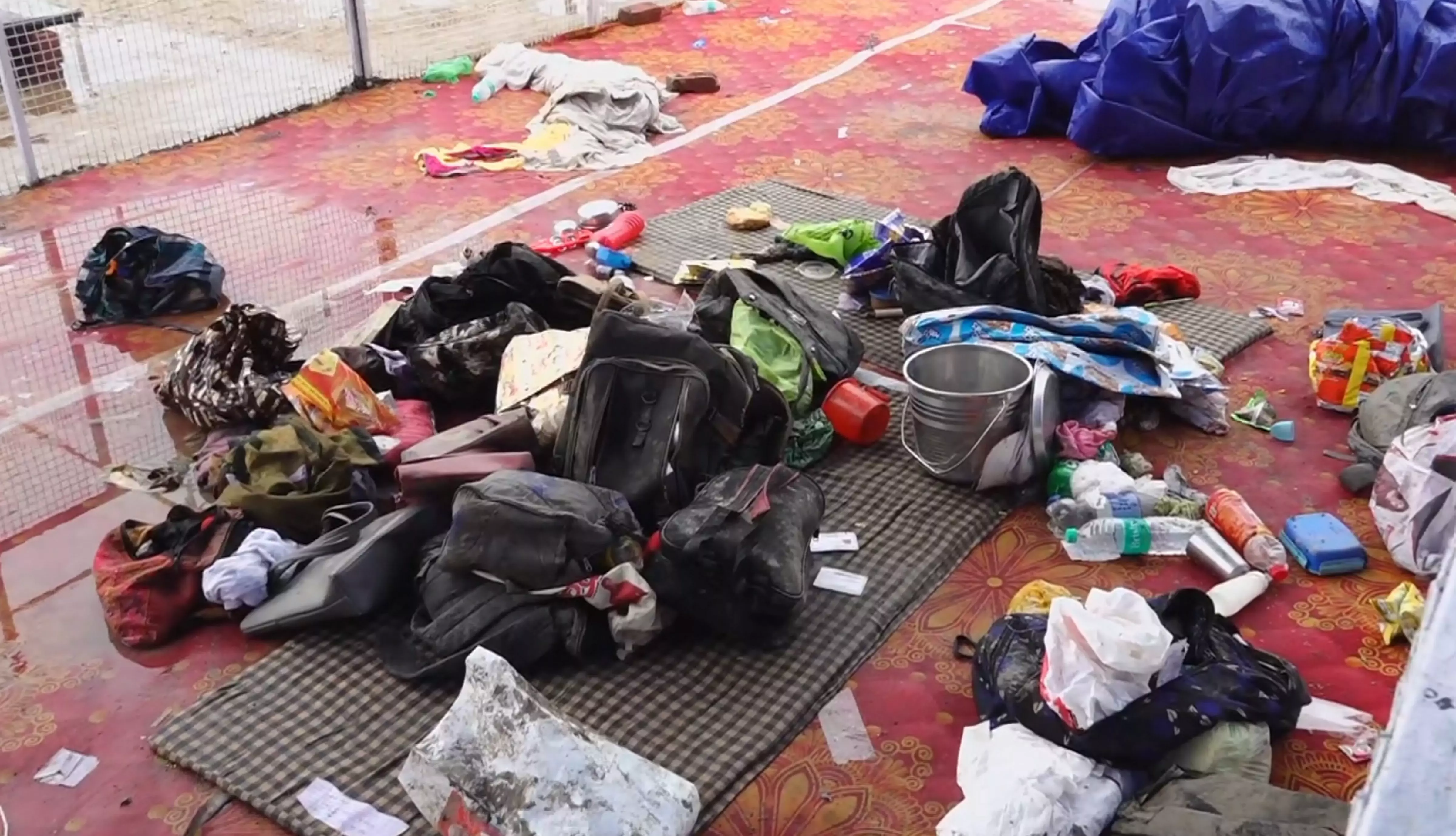 Bags and other belongings lying at the scene a day after a massive stampede that took during a satsang (religious congregation), in Sikandara Rao area in Hathras district, on Wednesday, July 3. PTI