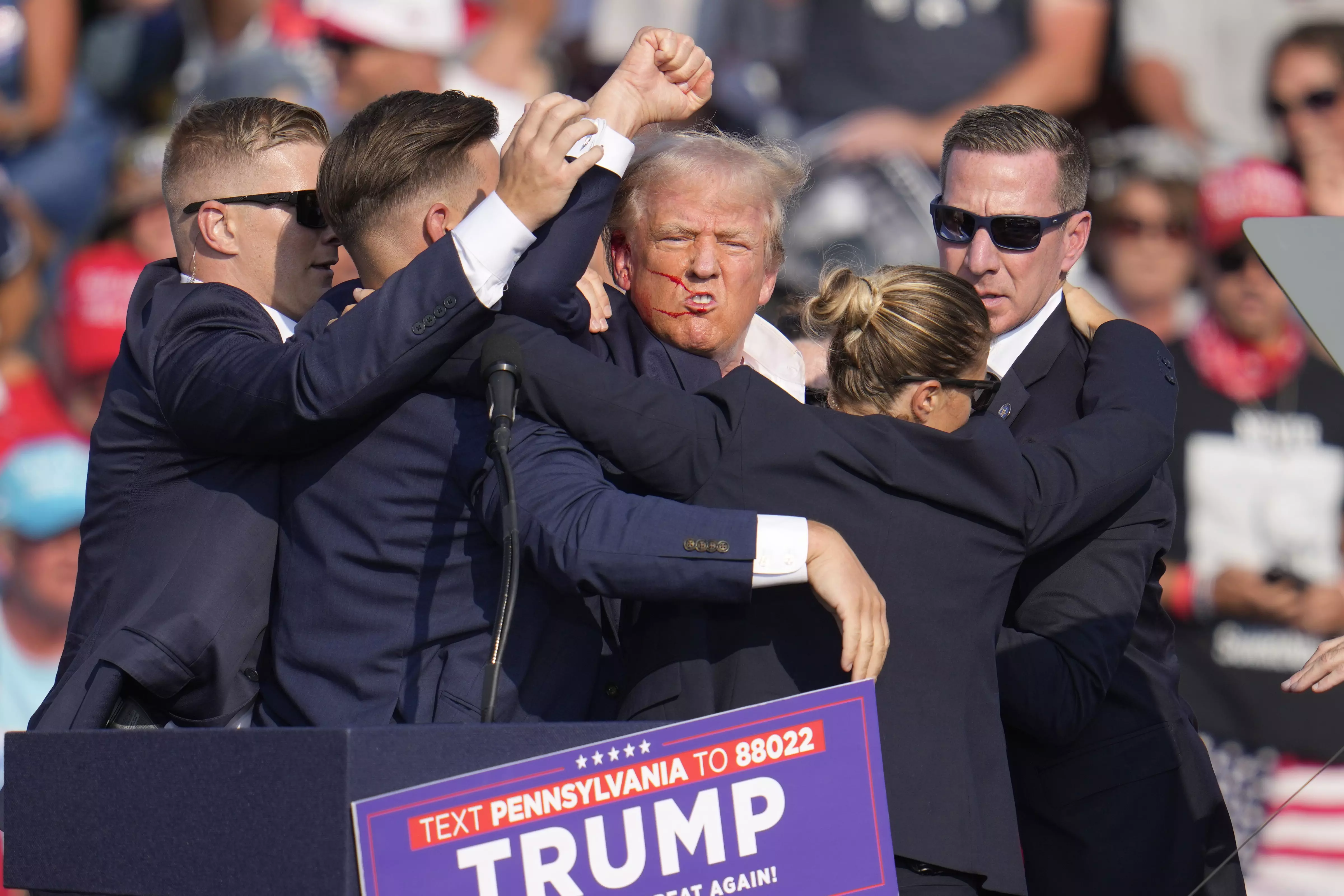 Republican presidential candidate former President Donald Trump is helped off the stage at a campaign event in Butler, Pennsylvania, USA, on Saturday, July 13. AP/PTI