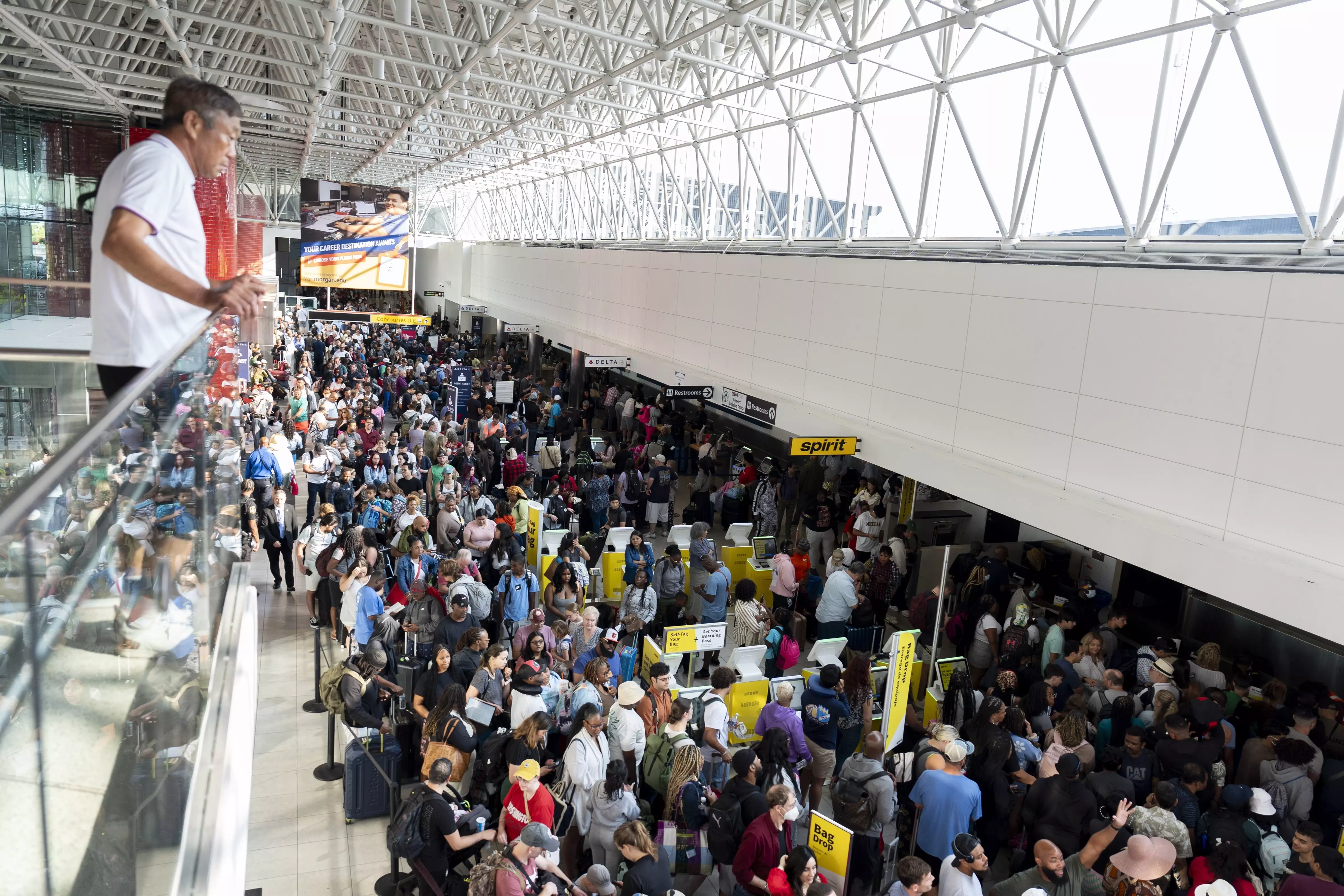 Travelers wait in line at Baltimore/Washington International Thurgood Marshall Airport in Baltimore, USA, Friday, July 19. AP/PTI