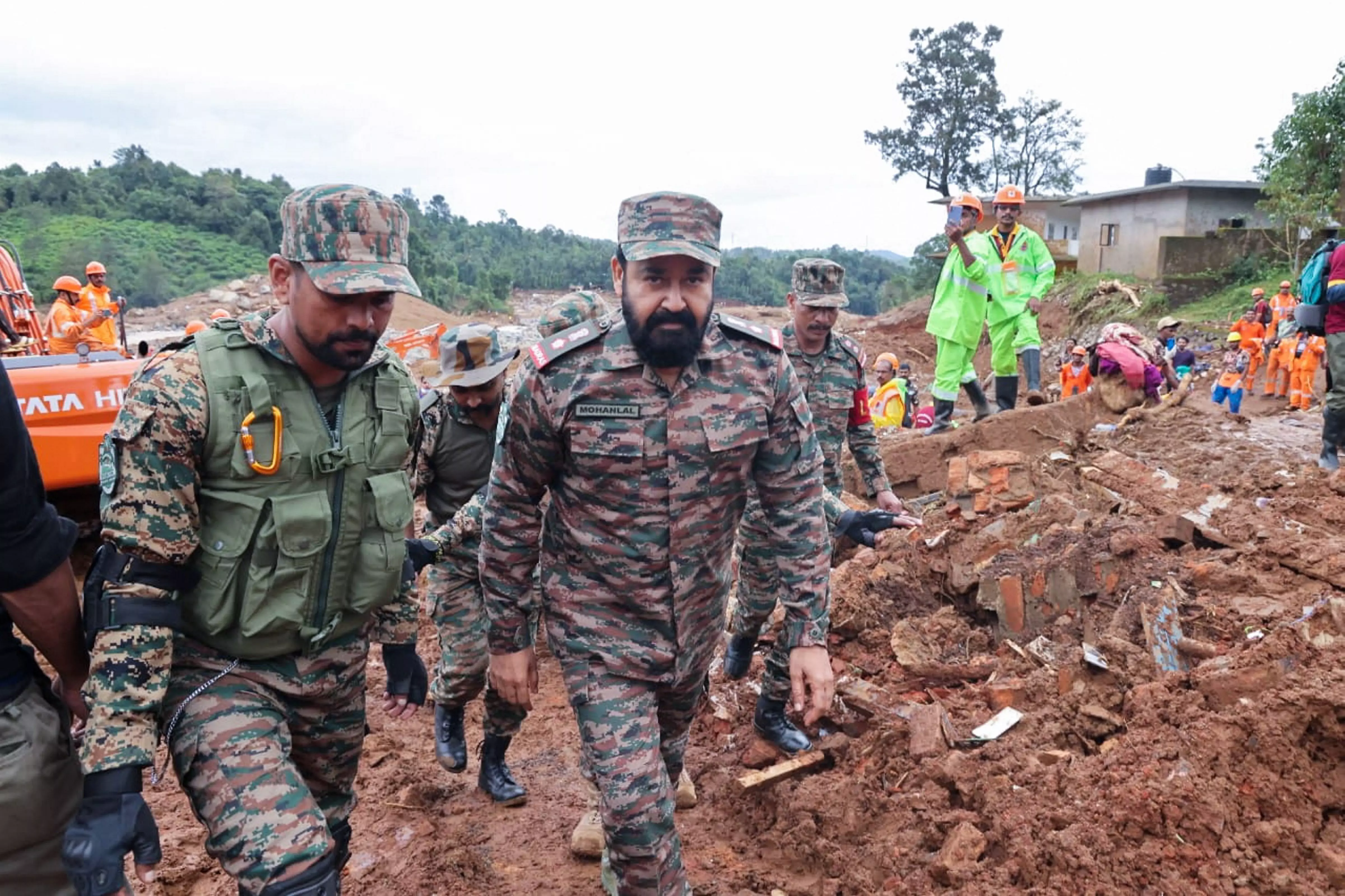 Actor and Lt. Col.(Honorary) Mohanlal (right) of 122 TA (Madras) with others during his visit to a landslide-affected area, in Wayanad district, Saturday, August 3. Photo: PTI/Defence PRO