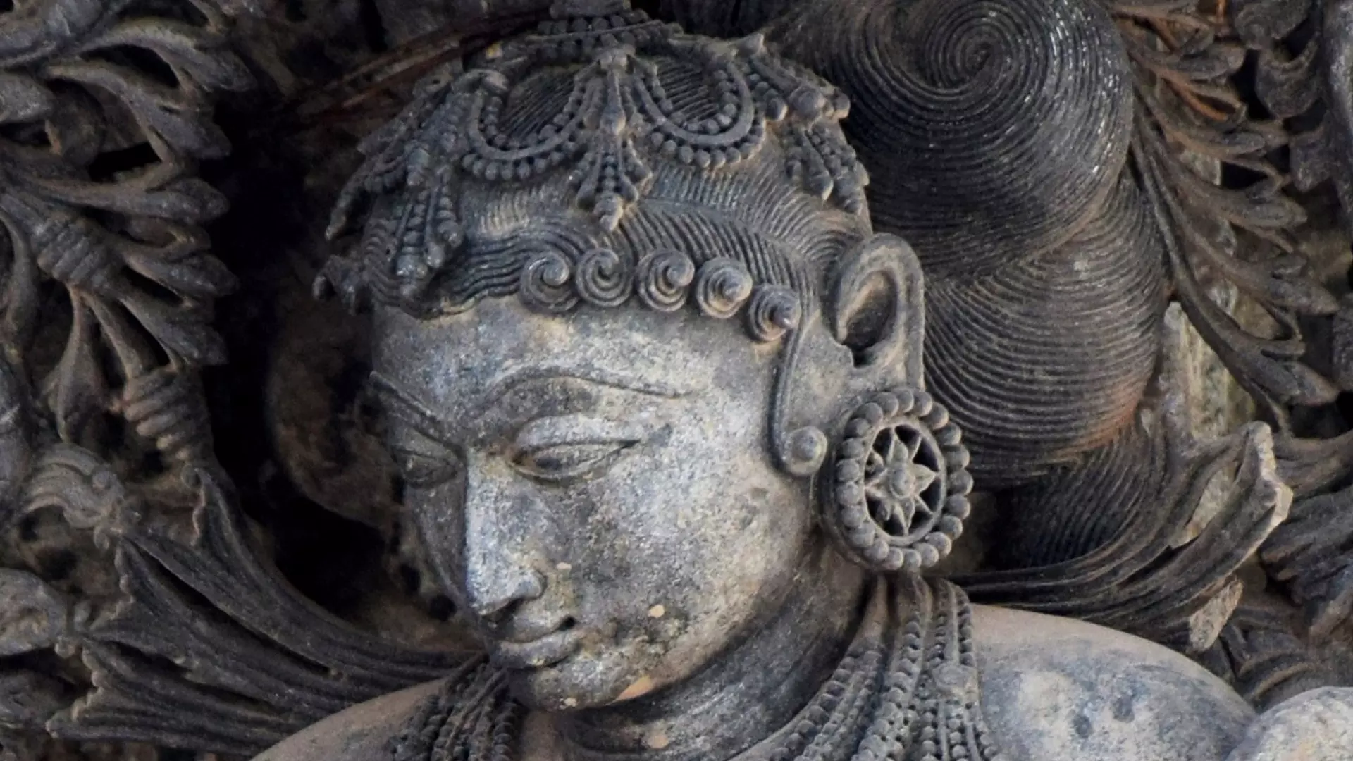 Curls on forehead and curling creepers in Hoysala art.