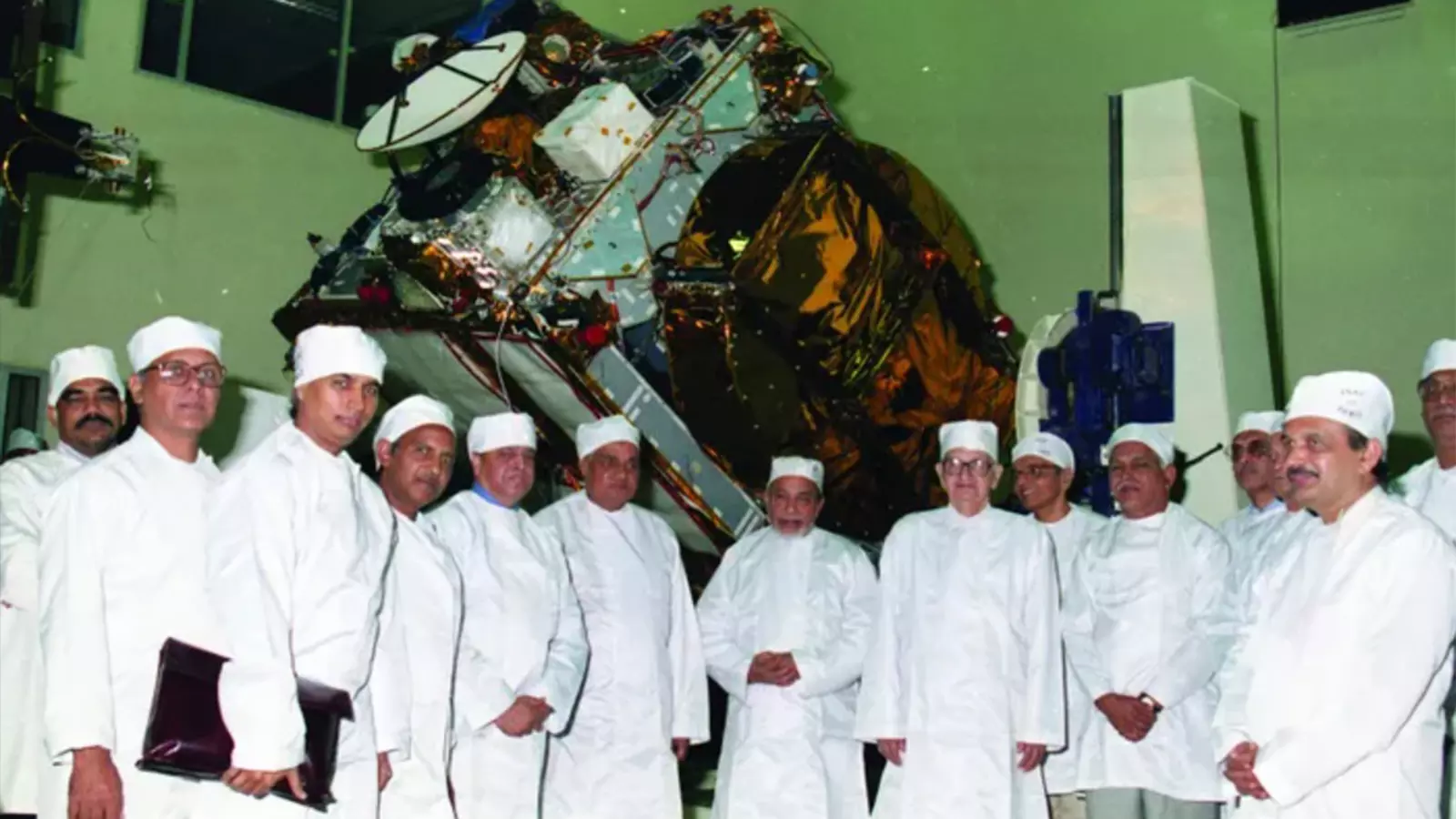 Prime Minister AB Vajpayee seen against the background of the fully integrated INSAT-2E.