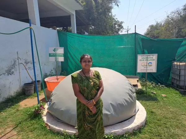 Jagrutiben Samanthbhai Parmar infront of her biggas plant. Photos: On arrangement