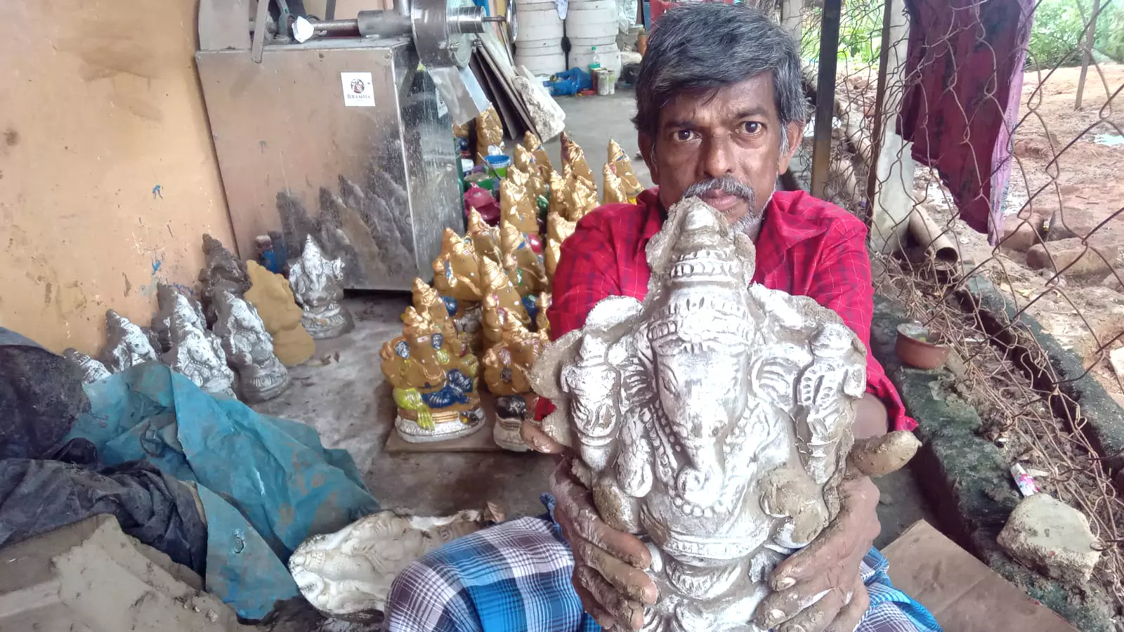 Gajendran poses with the idol he made.