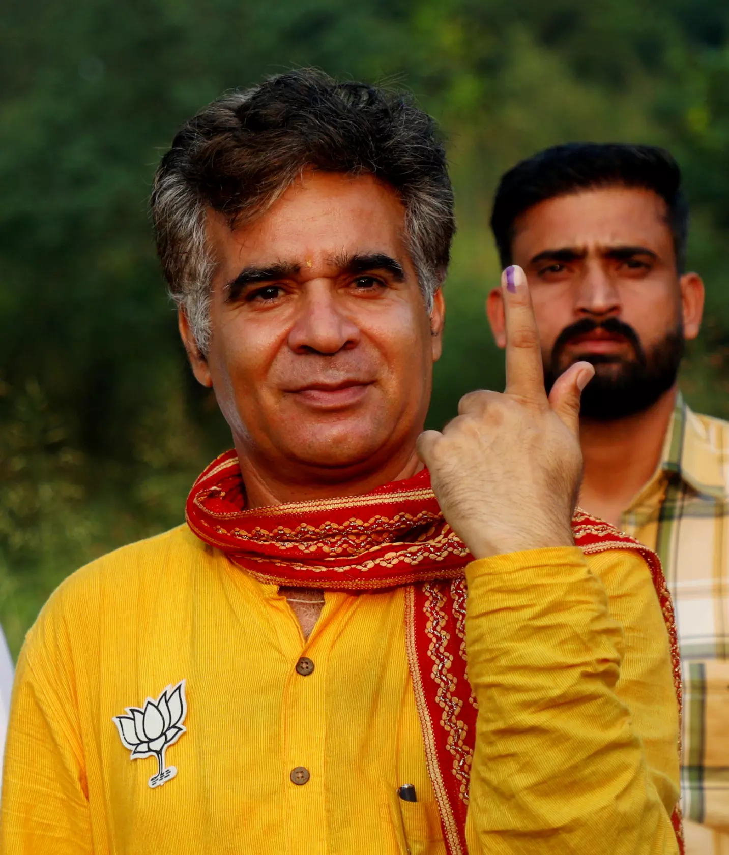 J&K BJP President Ravinder Raina shows his inked finger after casting his vote at a polling station during the second phase of J & K Assembly polls, at Lamberi in Nowshera, in Rajouri district, Wednesday, September 25. PTI