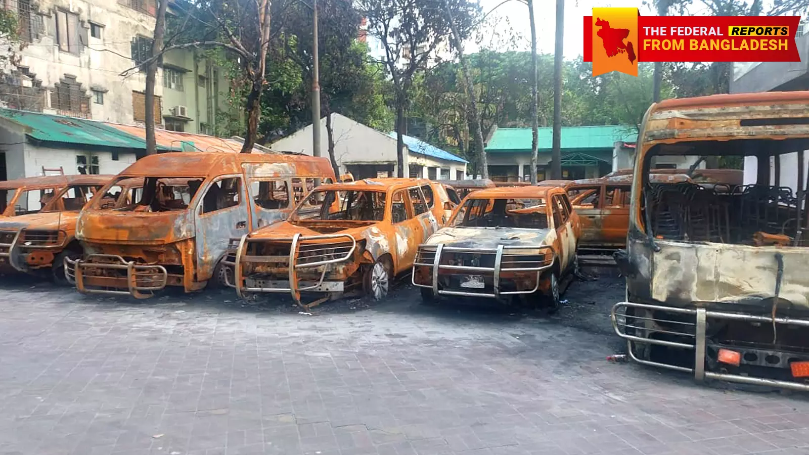 EMBERS STILL BURNING? A series of vehicles which were set ablaze lined up on a street in Dhaka.