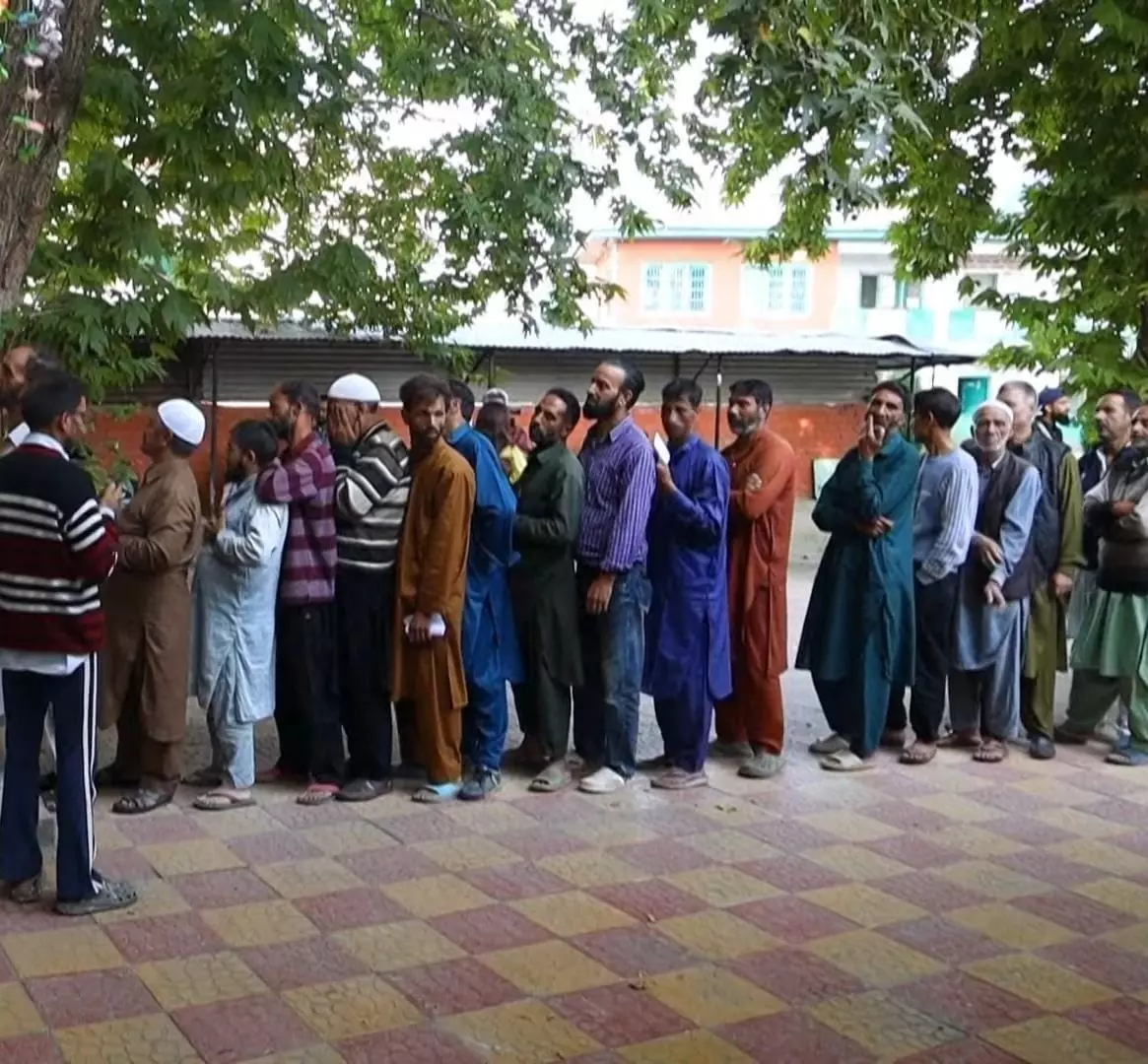 Voters queue up at a polling booth in Baramulla. PHoto: Bilal Ahmed