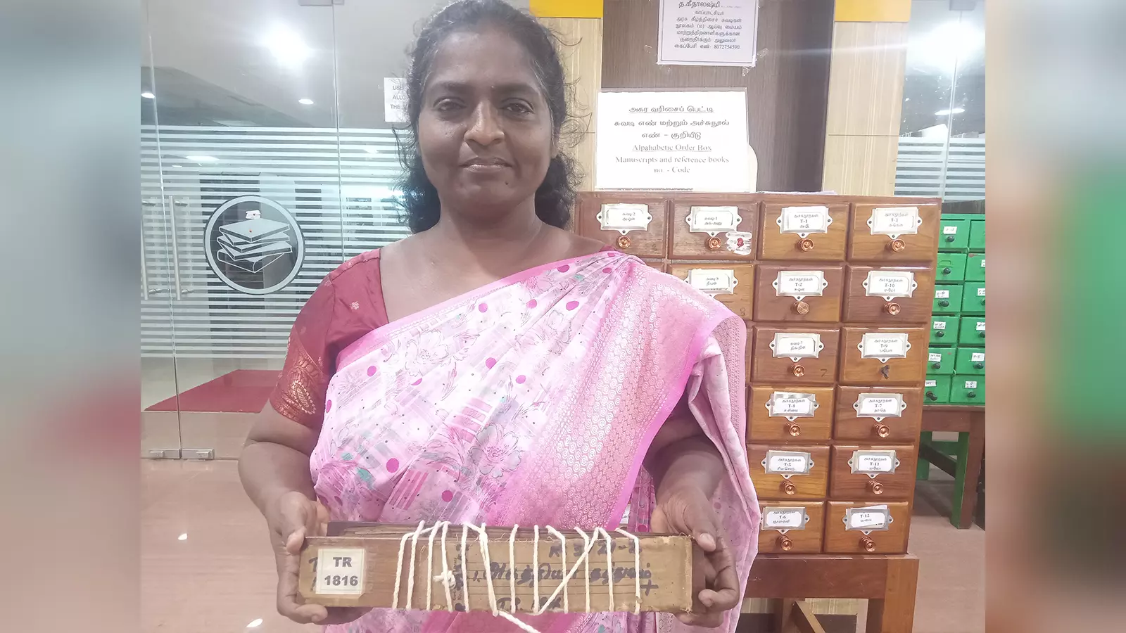 Curator R Geethalakshmi showing a well-preserved manuscript in the library.