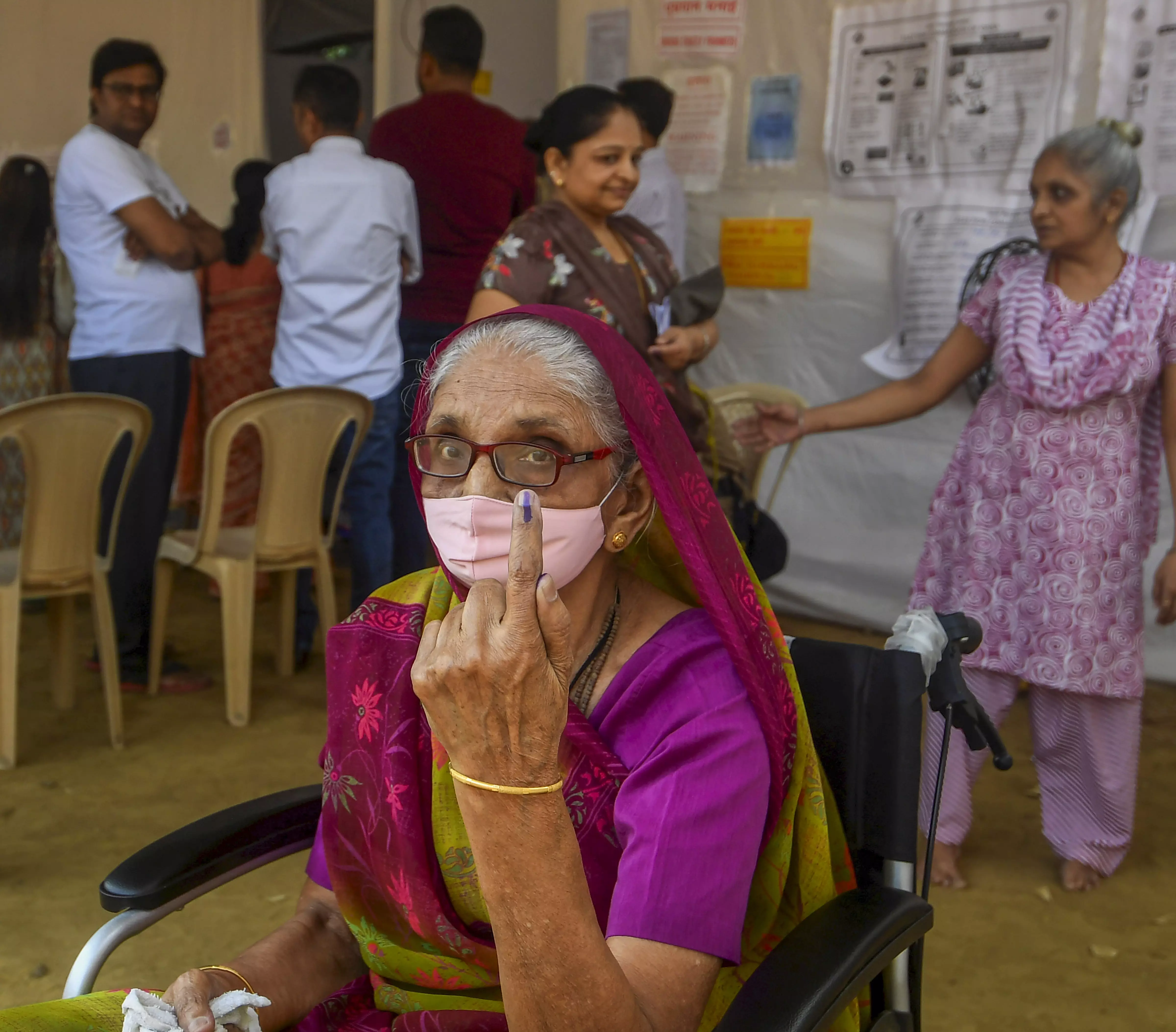 An elderly woman shows her finger marked with indelible ink after casting her vote in Mumbai during the Maharashtra Assembly elections | PTI 