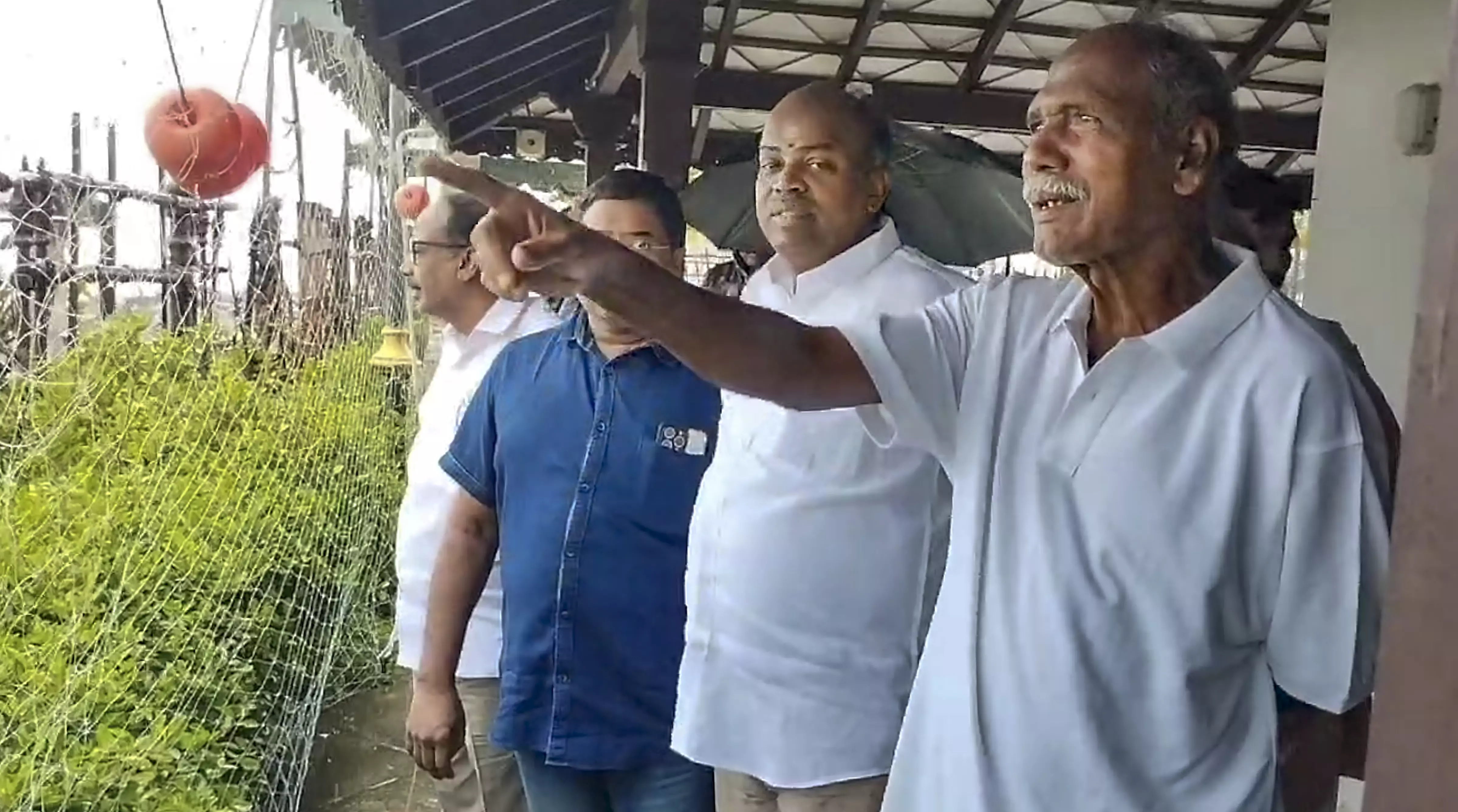 Puducherry Chief Minister N Rangasamy (right) visits a coastal area affected by heavy rains. PTI