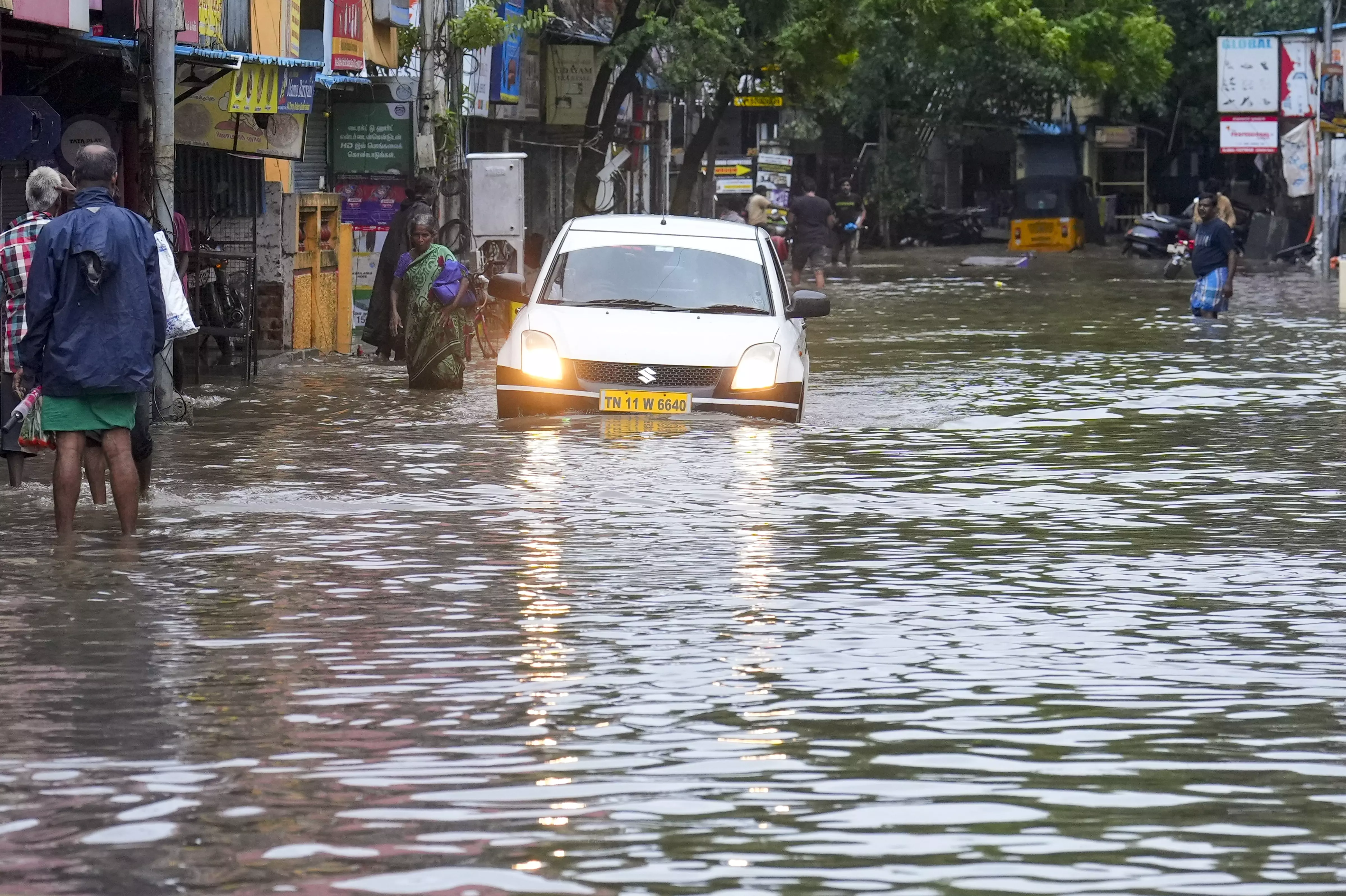 A car moves on a waterlogged road in Chennai on Saturday | PTI